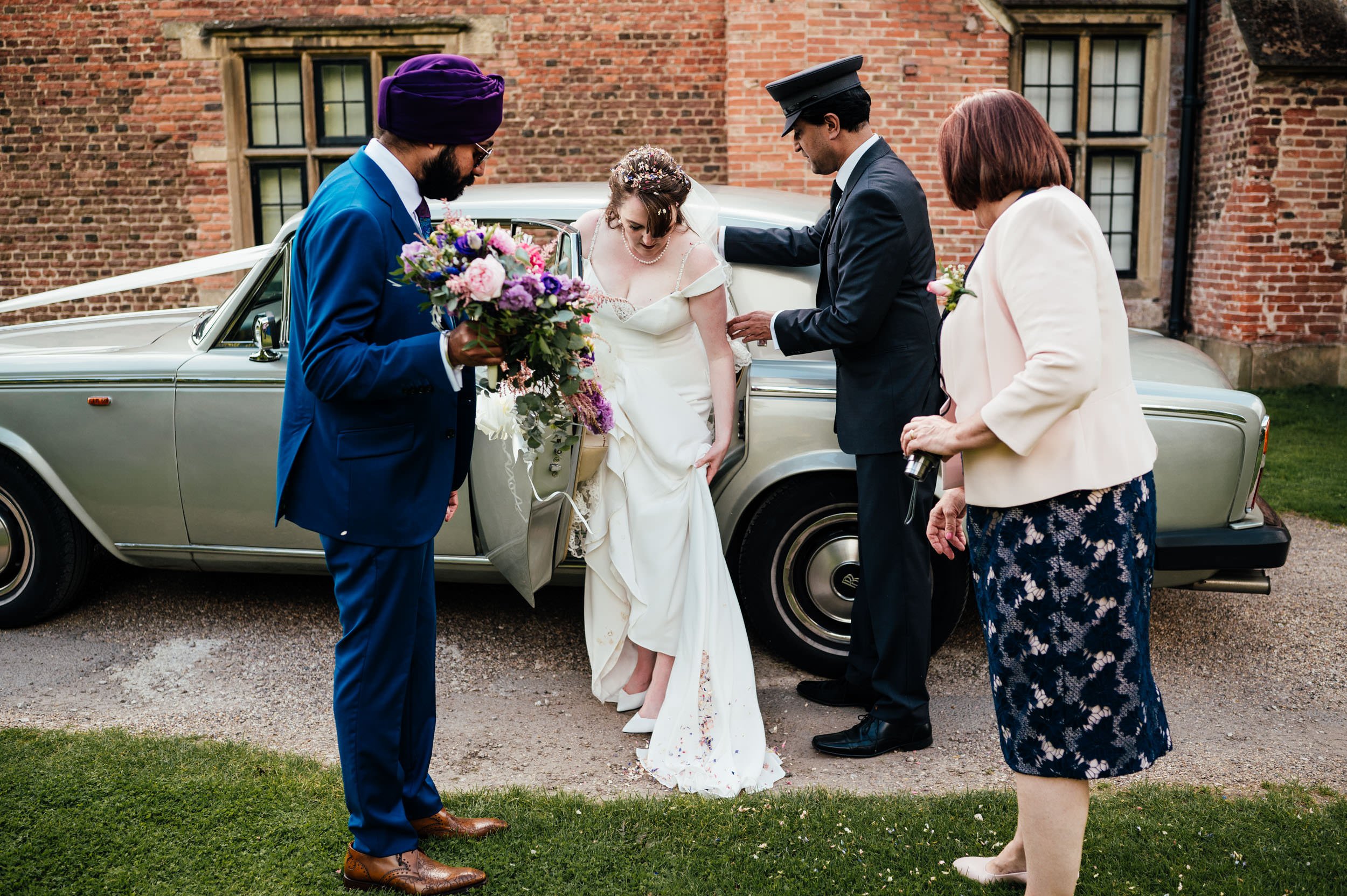 bride and groom getting out of the wedding car