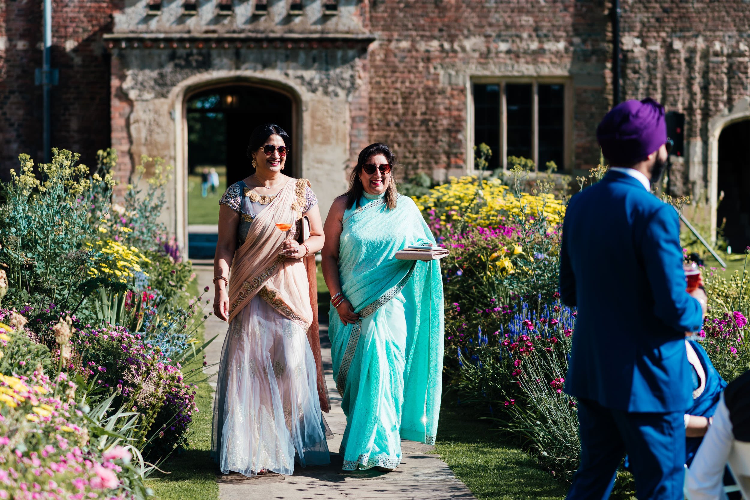 wedding guests in the flower garden at holme pierrepont hall