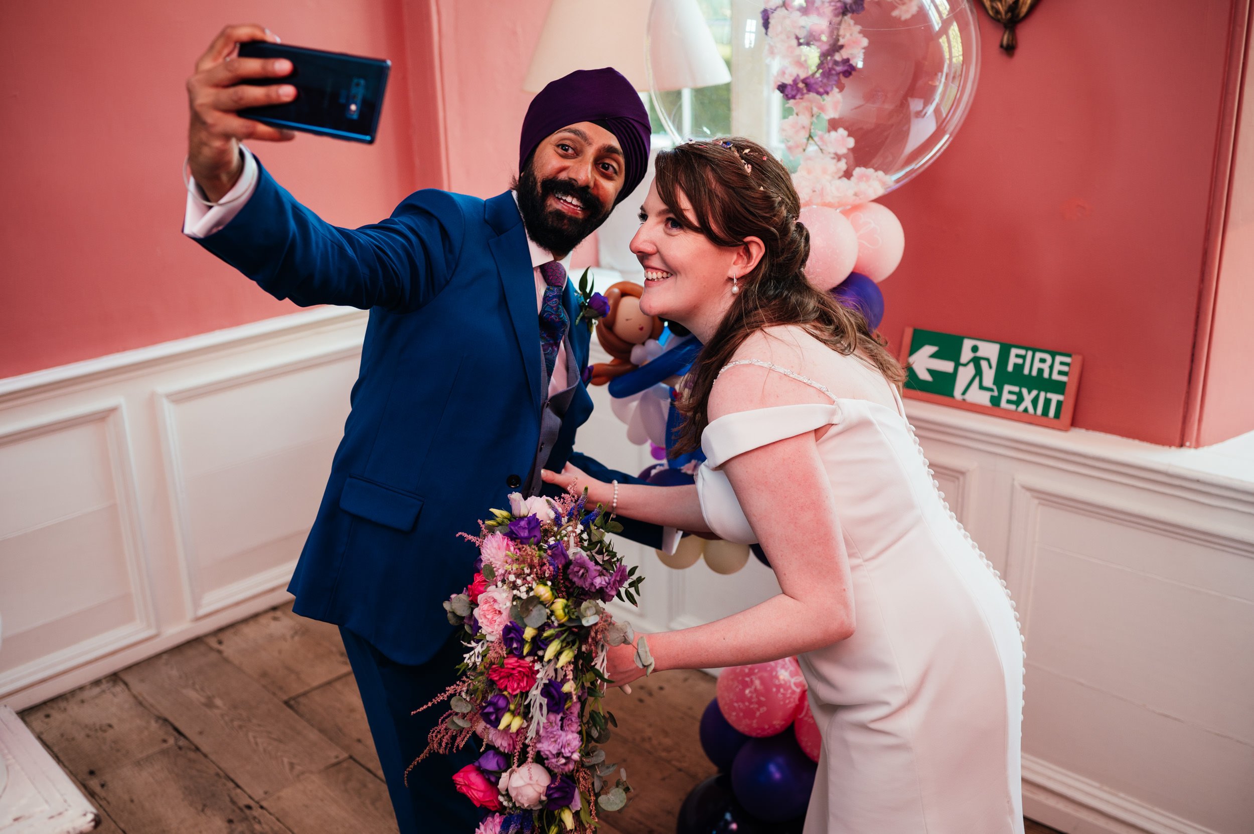 bride and groom take a selfie on the stairs