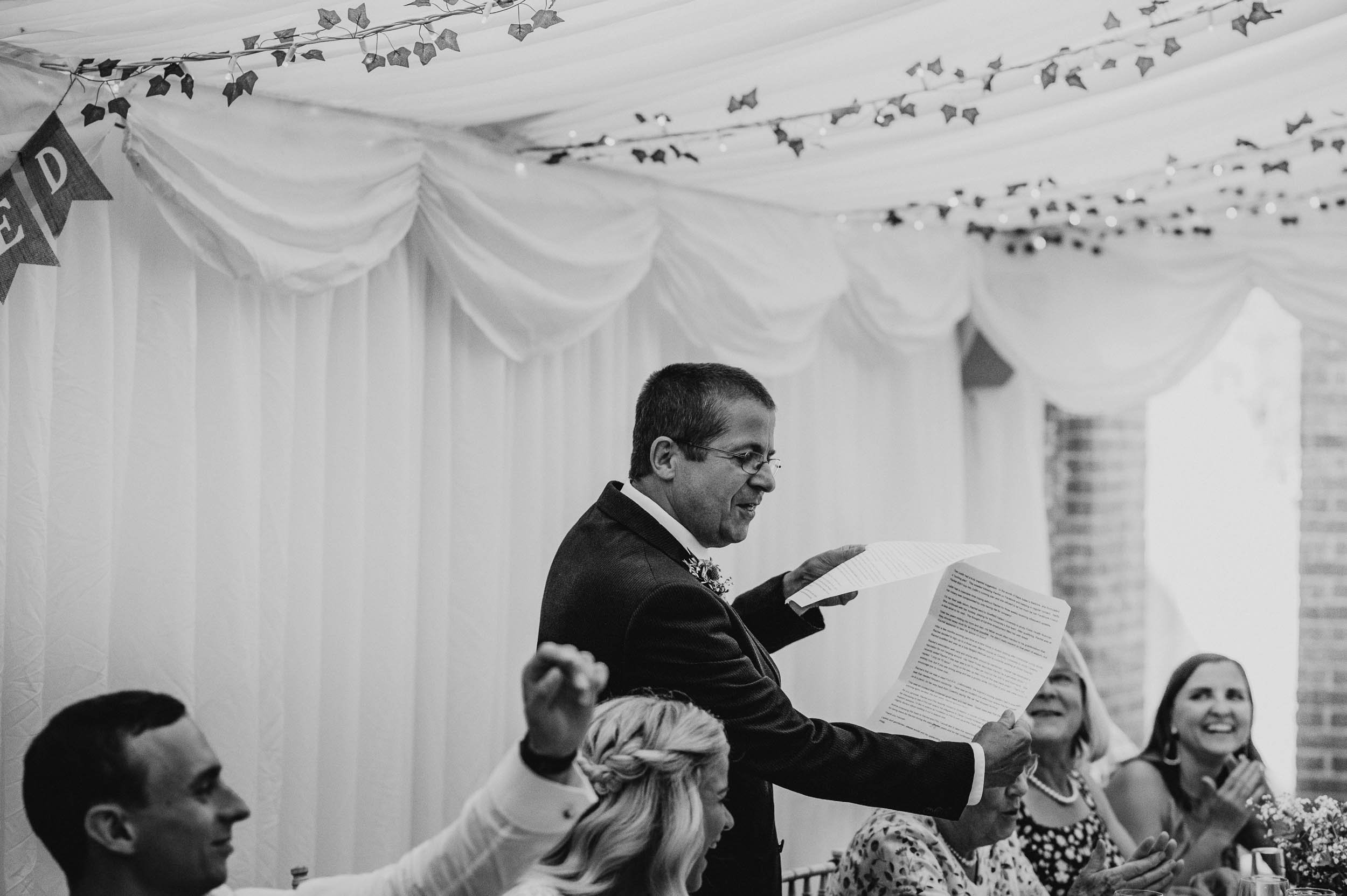 father of the bride reading his speech