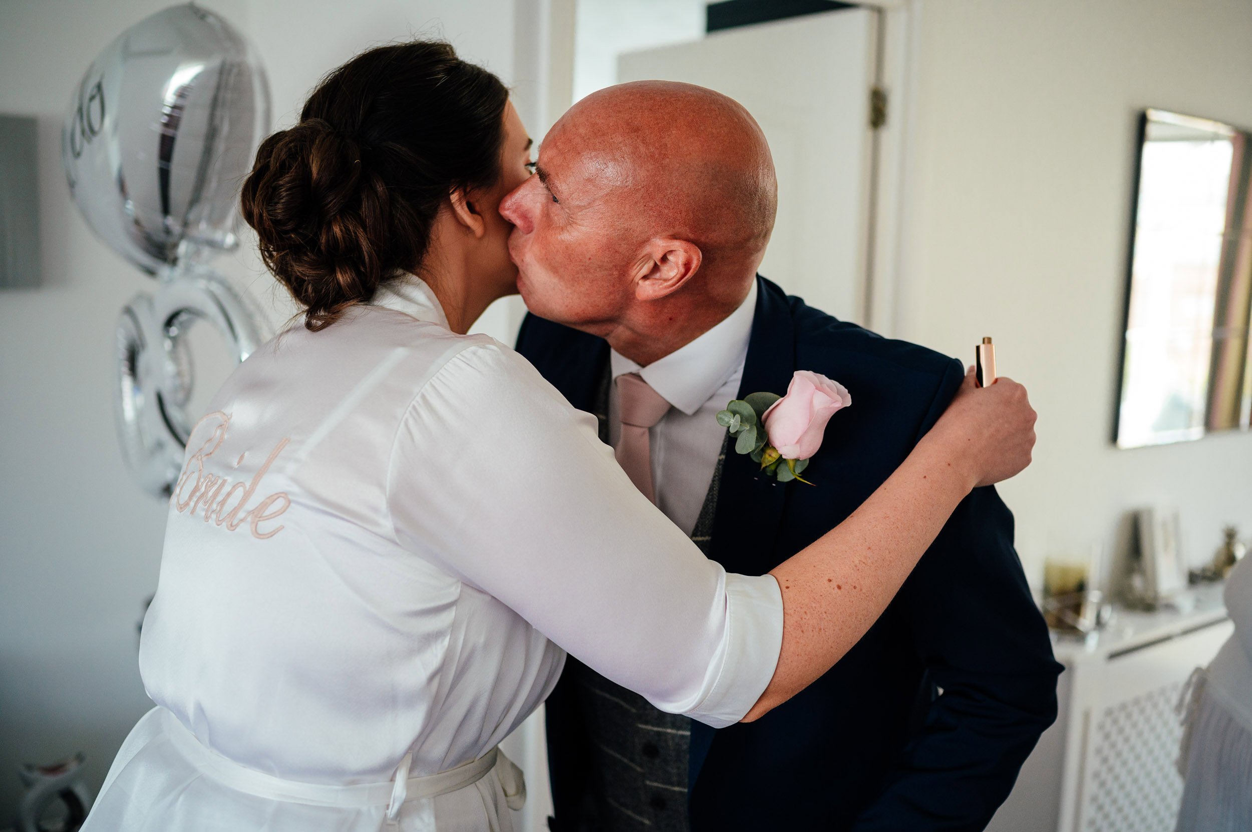 father of the bride kisses daughter