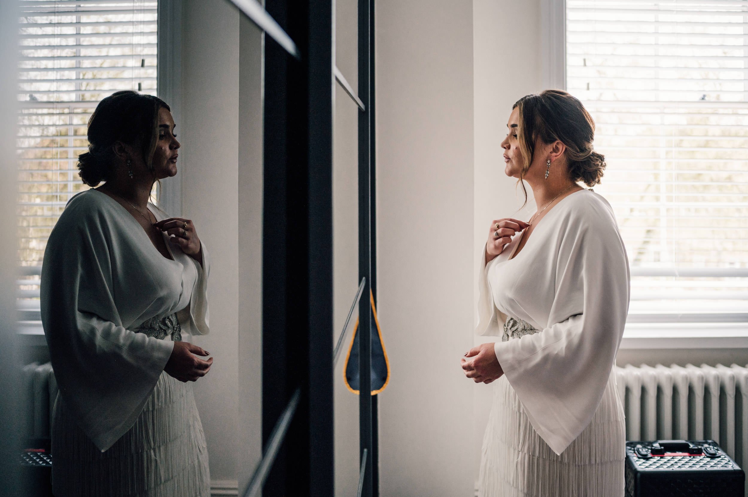 bride looking at herself in a mirror