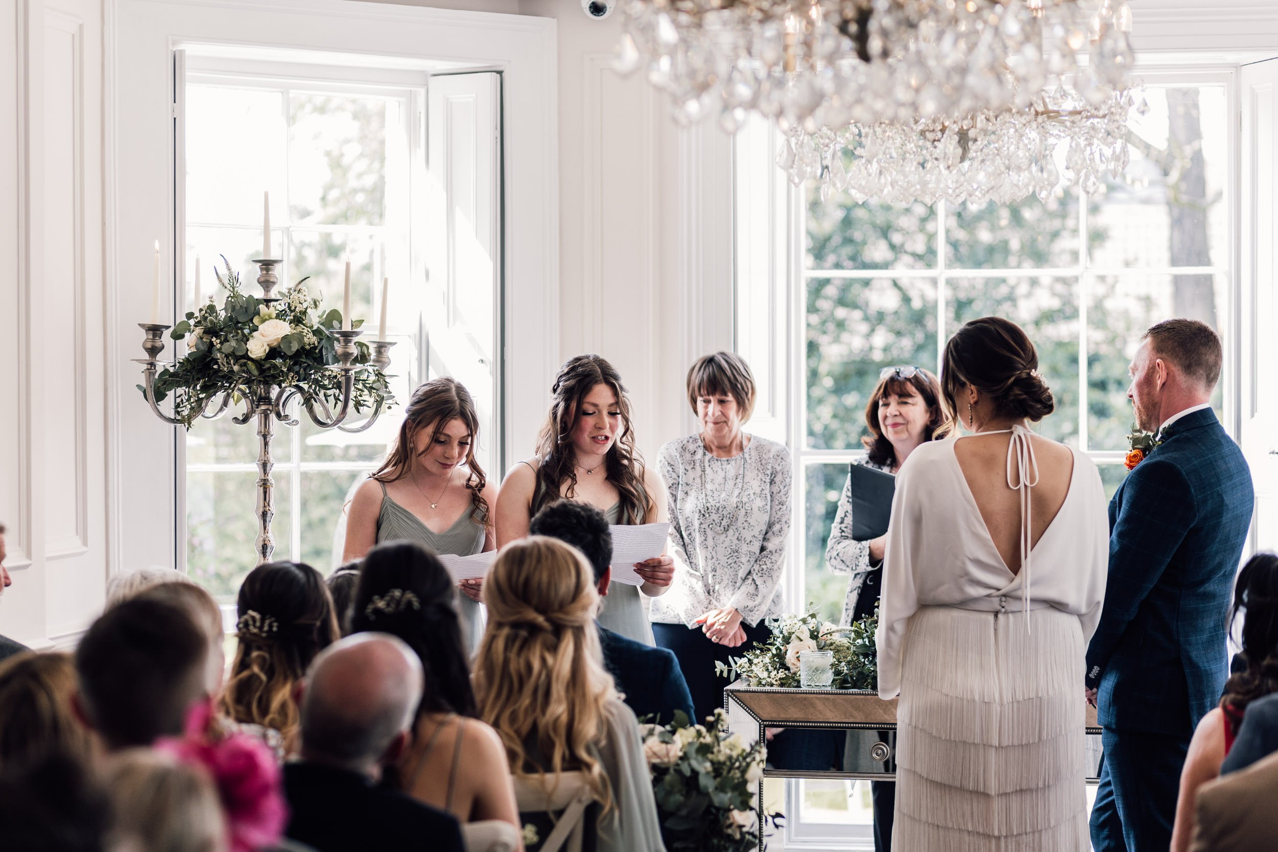 wedding guests reading a poem