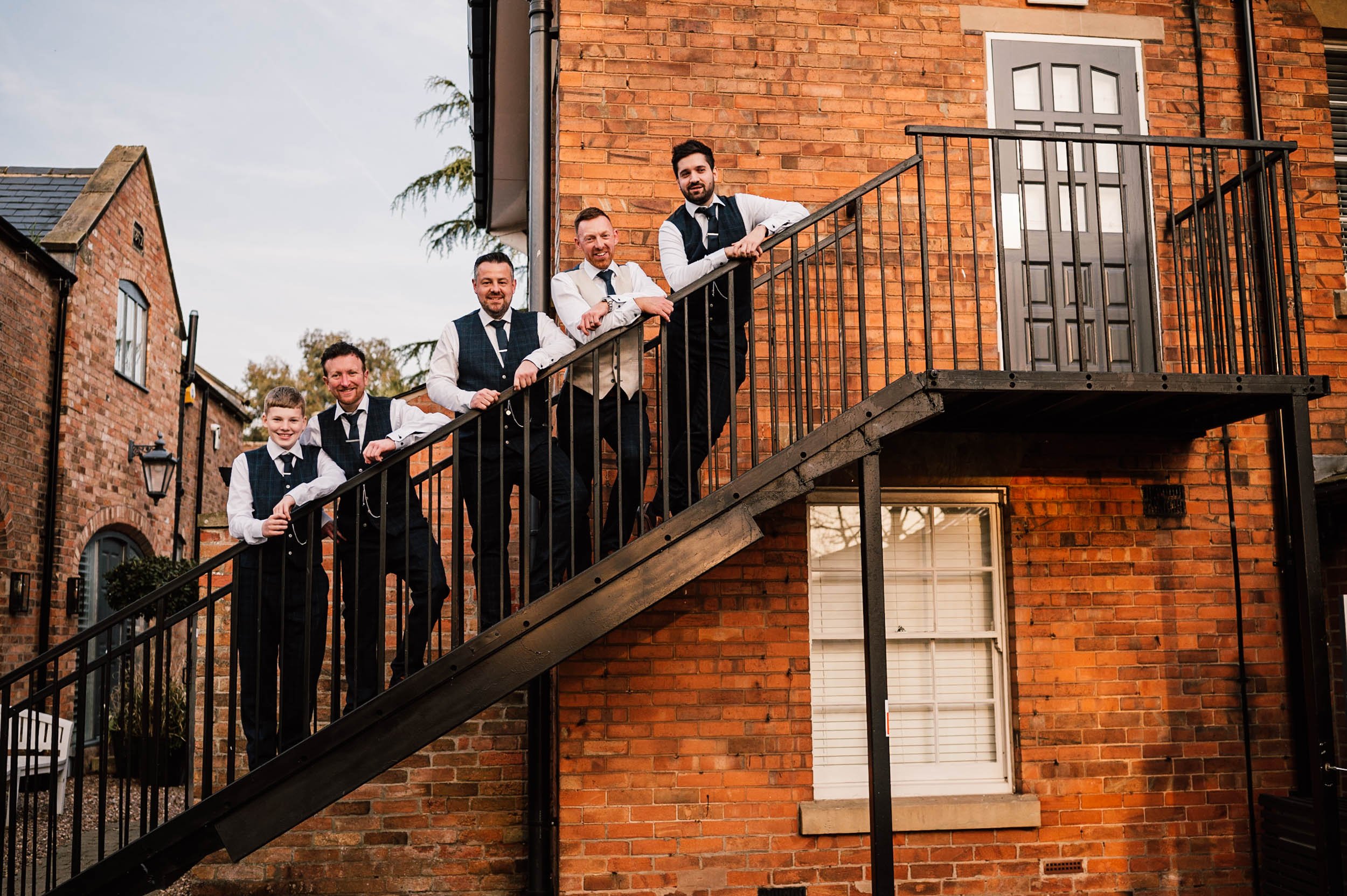 groomsman on the stairs at the old vicarage boutique hotel