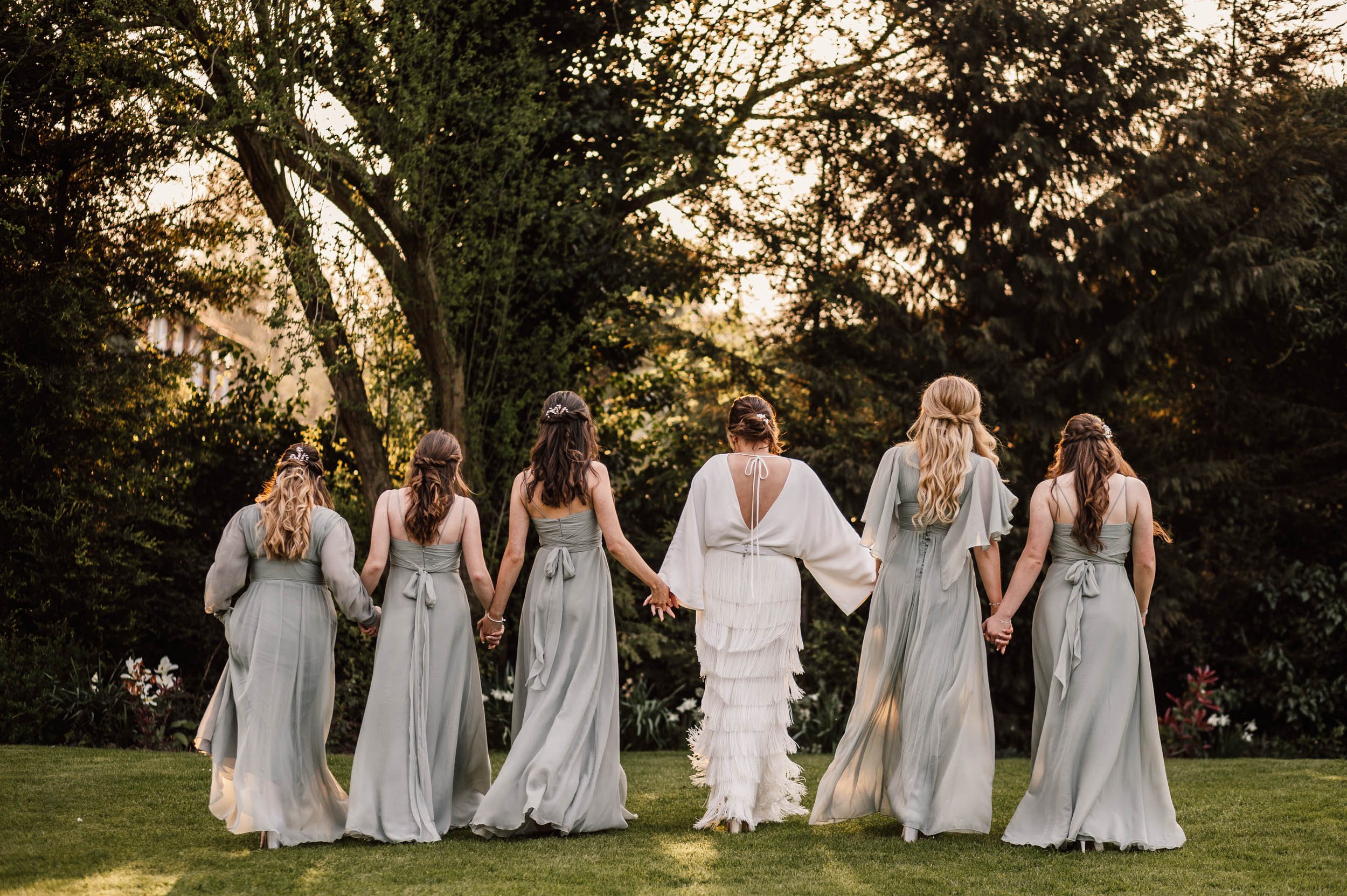 bride and bridesmaids walking together 