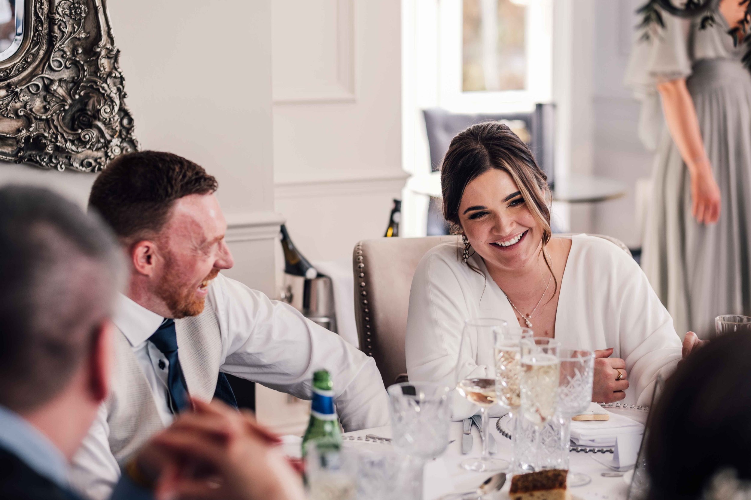 bride and groom laughing during their wedding speeches