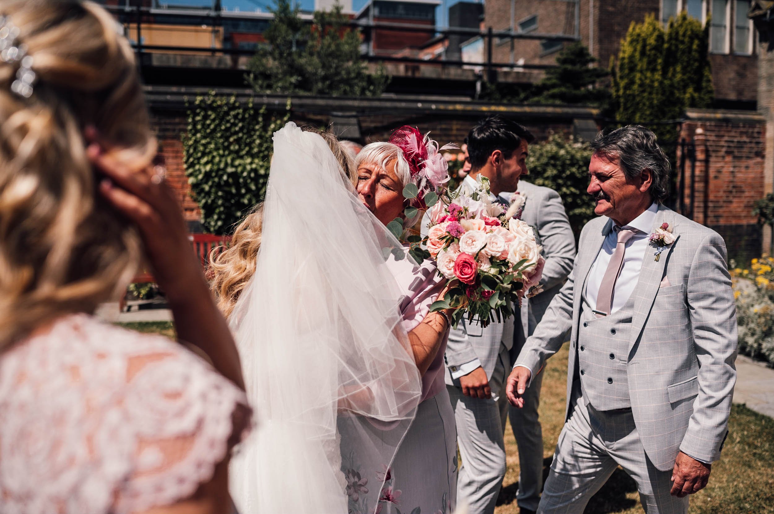 bride is congratulated by the grooms mother