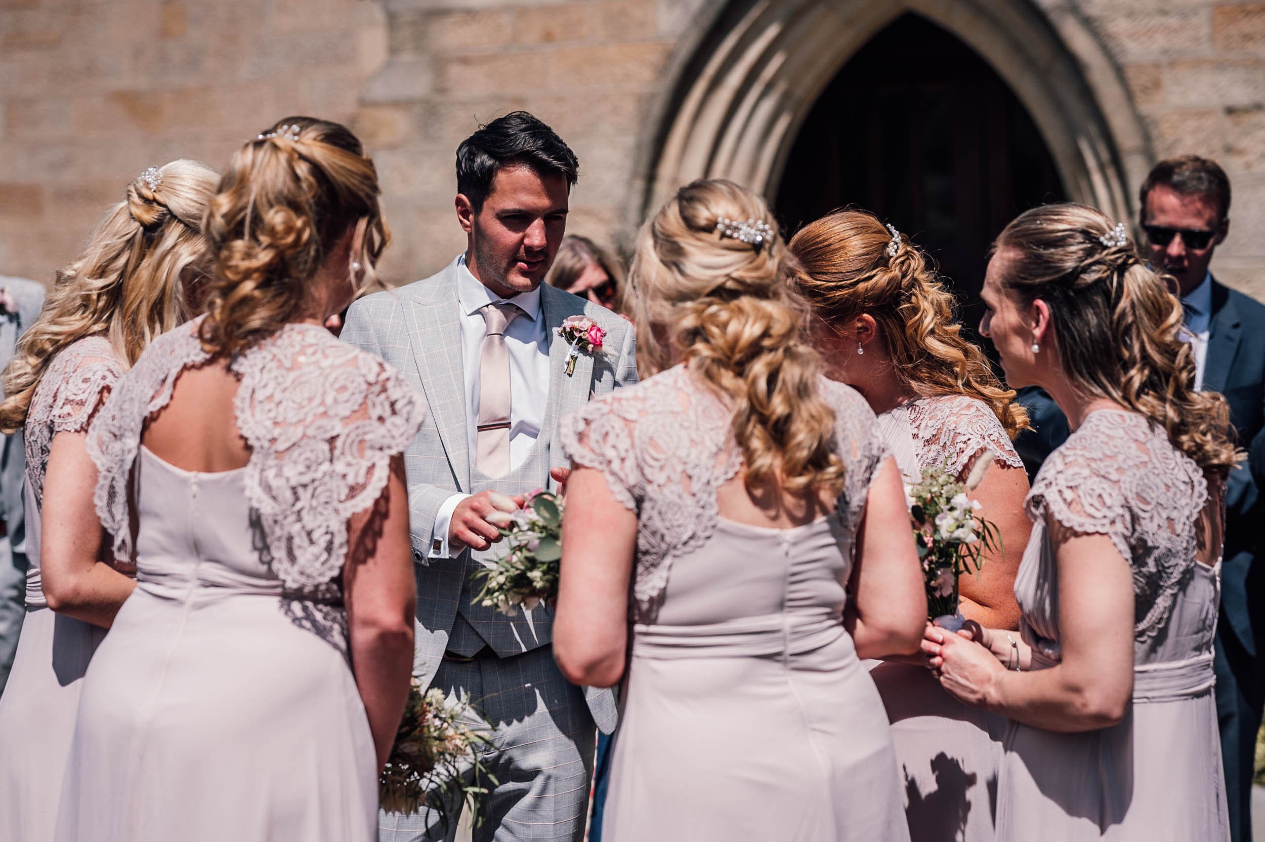 groom and bridesmaids laughing