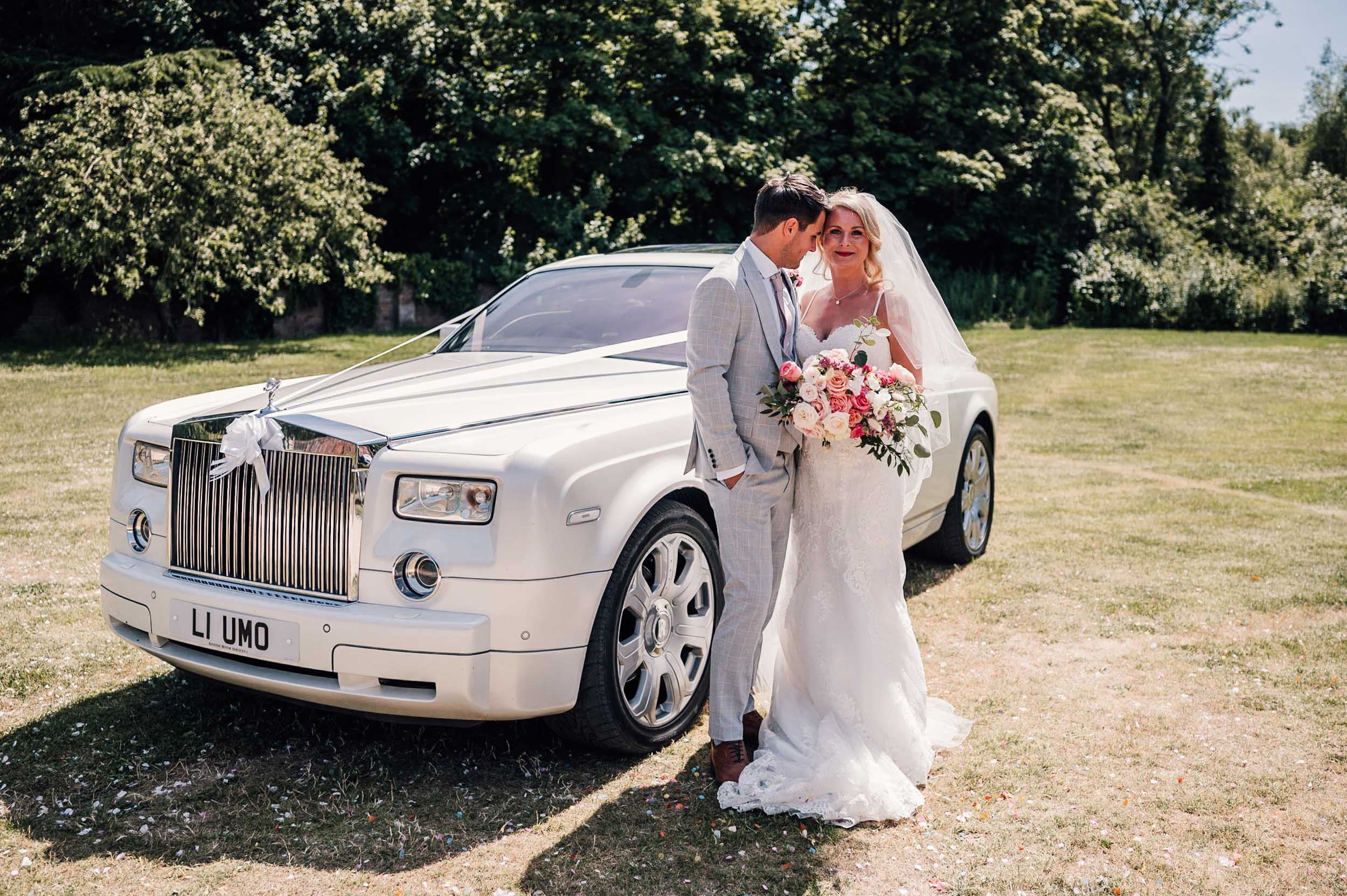 bride and groom with their wedding car