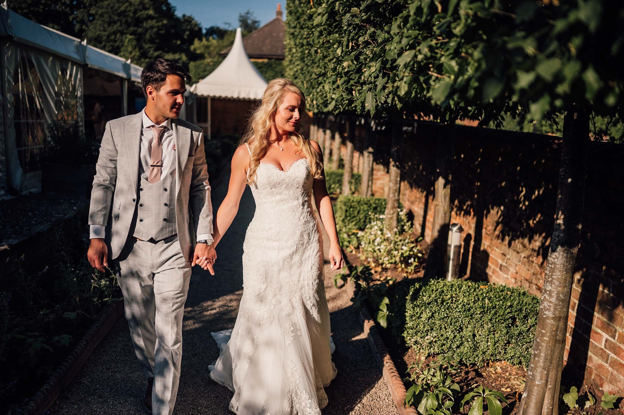 bride and groom walking in the gardens at the walled garden beeston fields