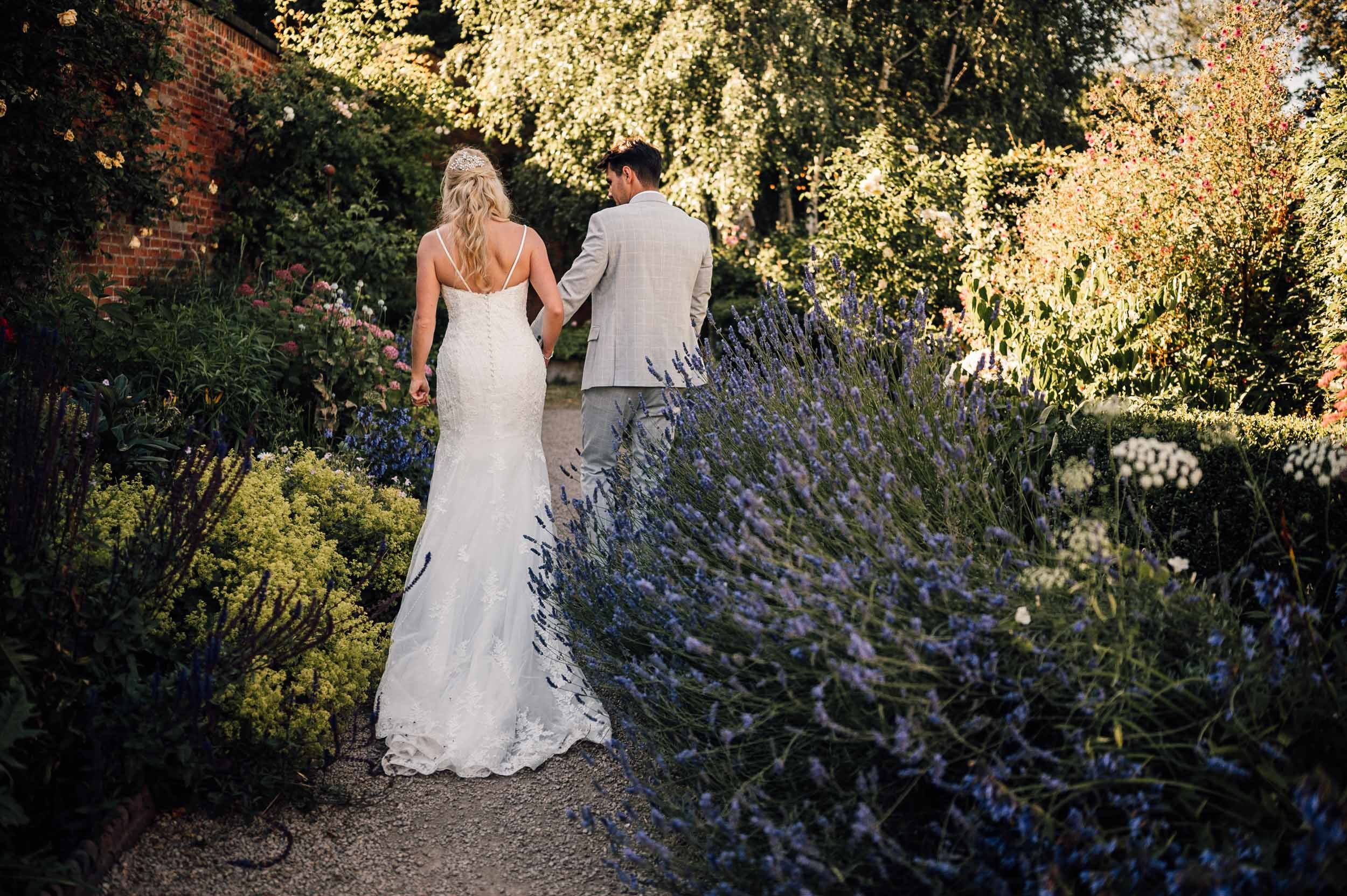 bride and groom walking at the Walled Garden, Beeston Fields, Nottingham