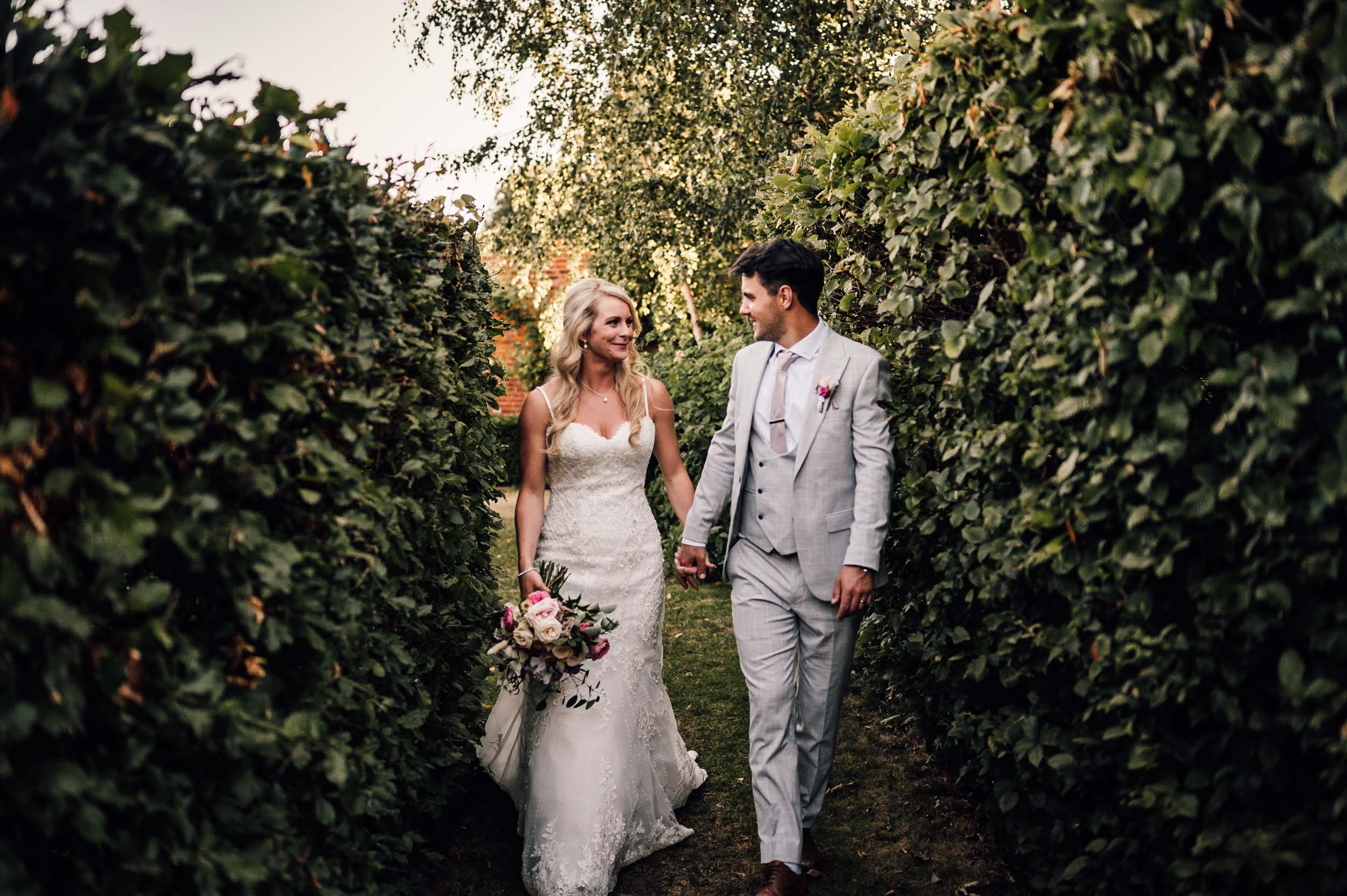 bride and groom walking at the Walled Garden, Beeston Fields,