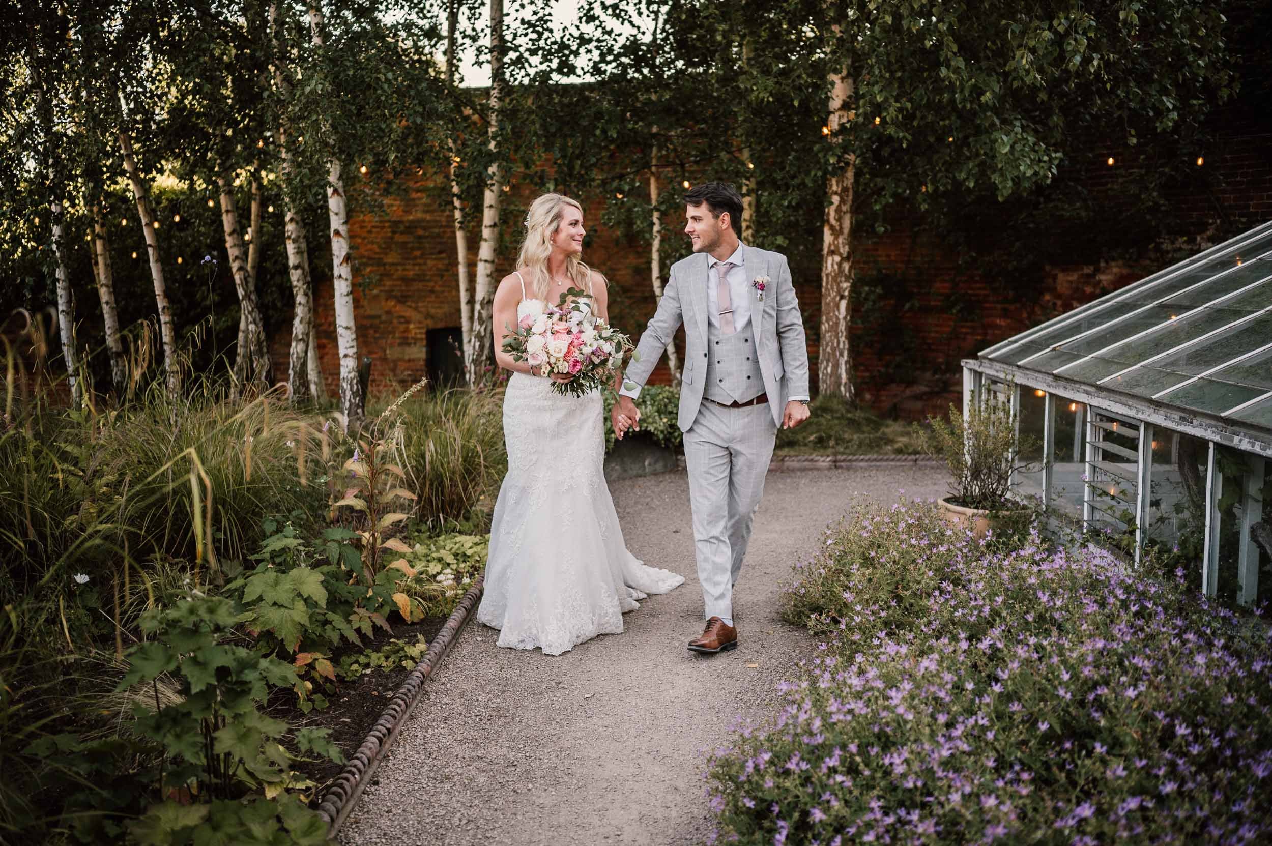 bride and groom walking at the Walled Garden, Beeston Fields,