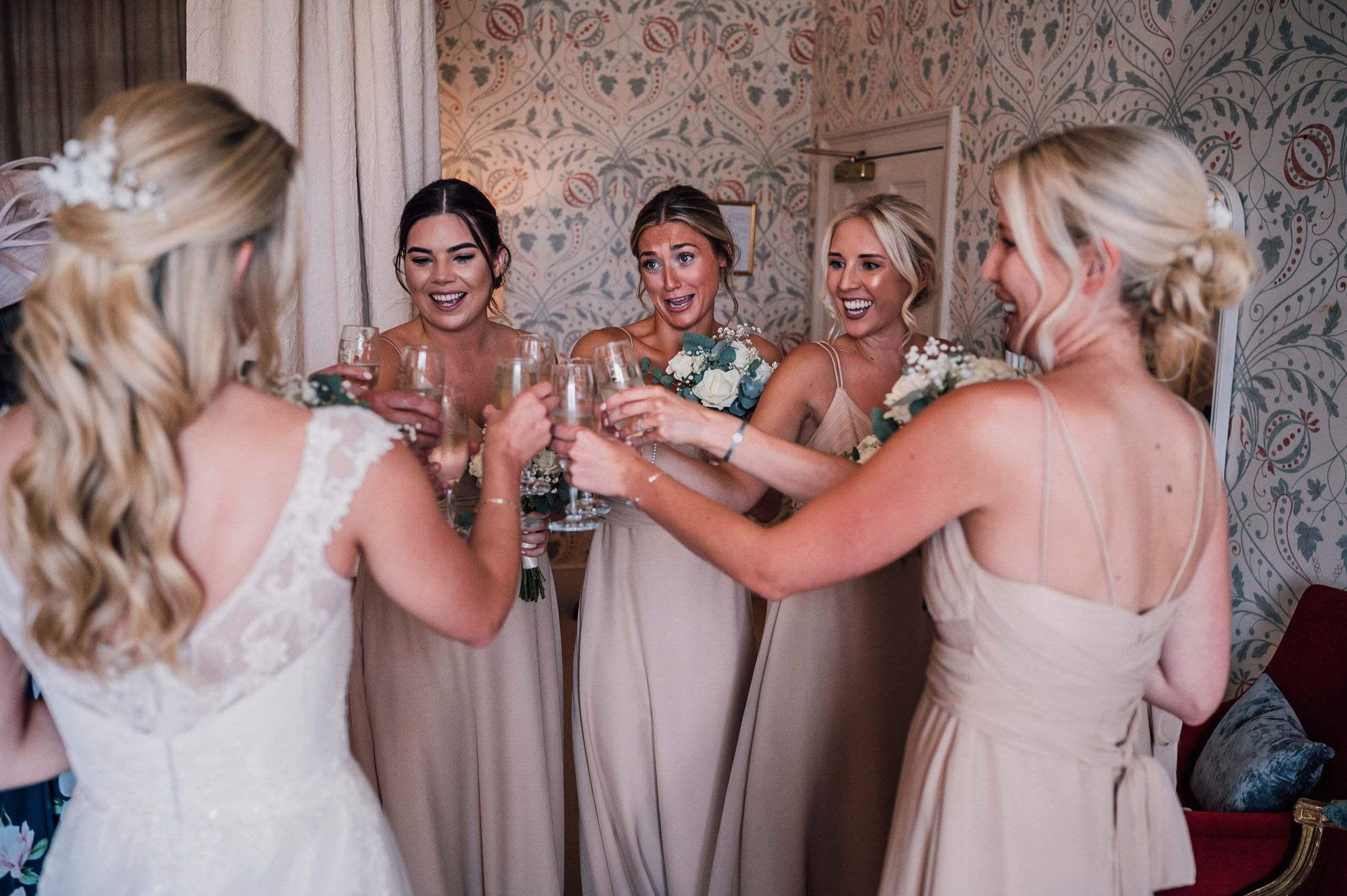 bridesmaids drinking champagne at Hodsock Priory