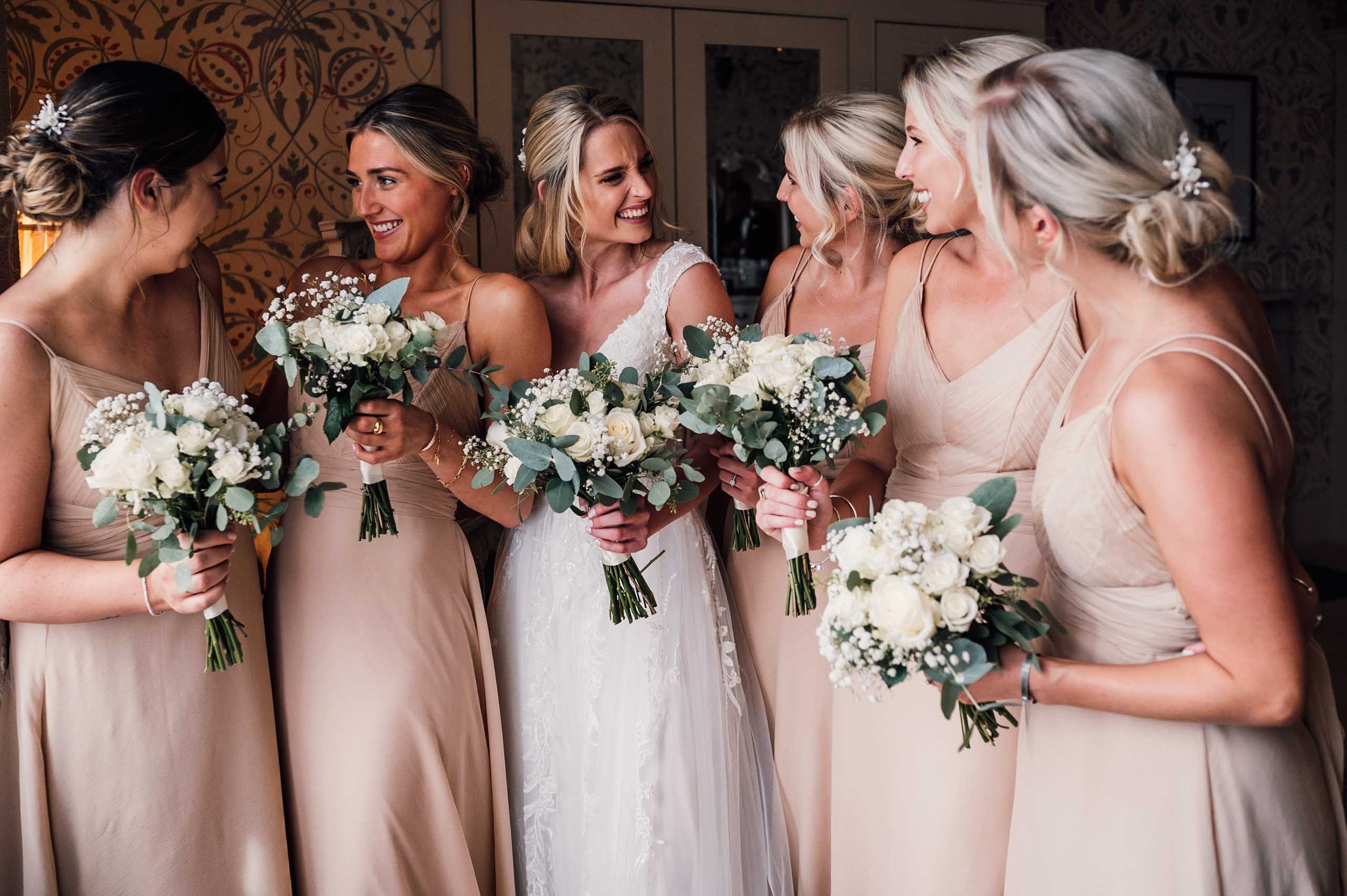 Bridesmaids talking with each other in the bridal suite at Hodsock Priory