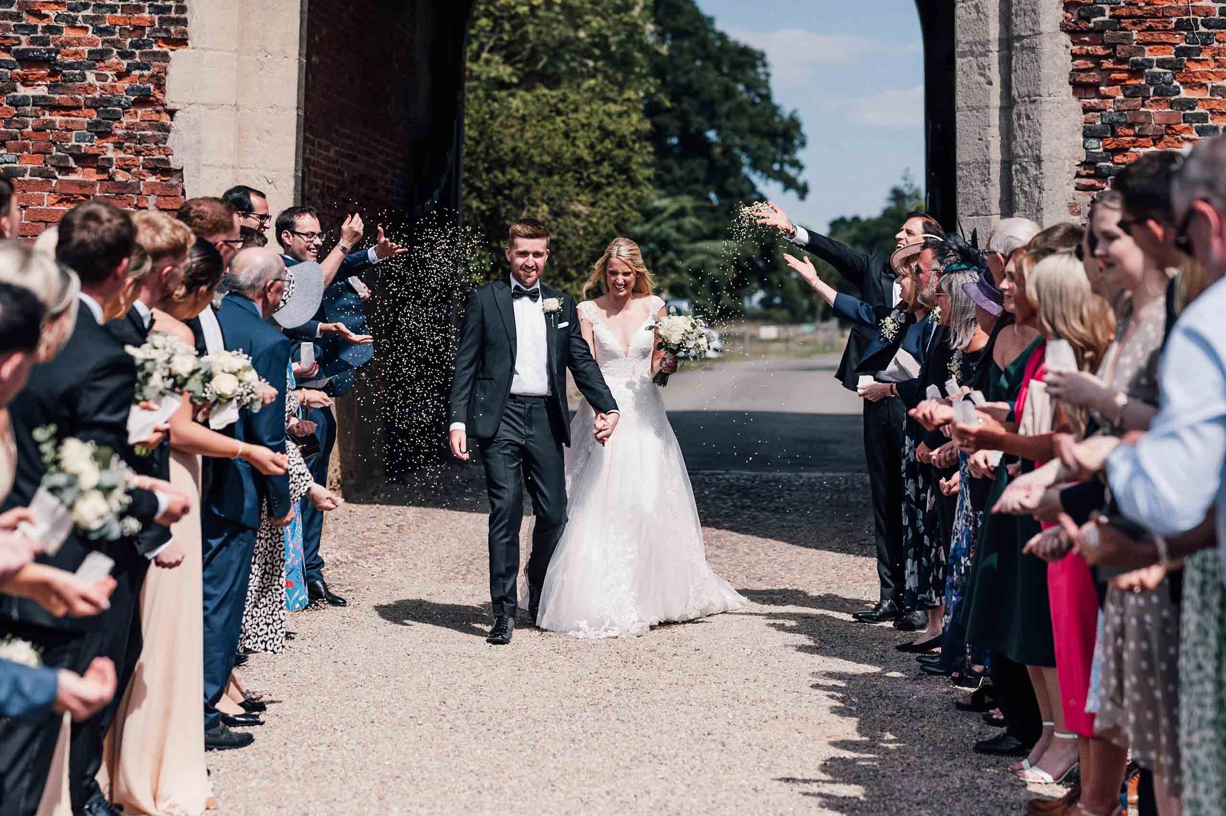 Bride and groom confetti walk at Hodsock Priory