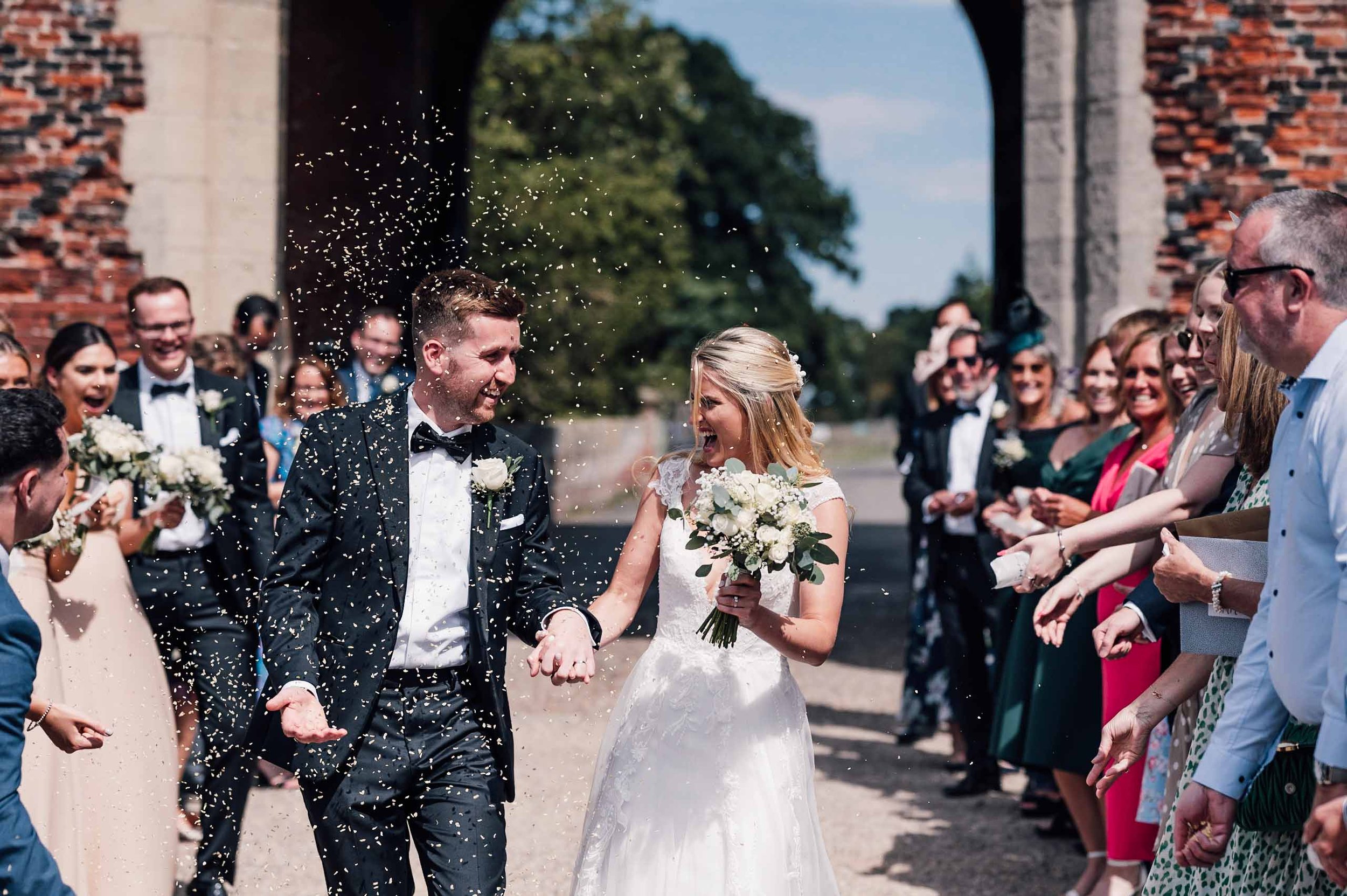 Bride and groom confetti walk at Hodsock Priory