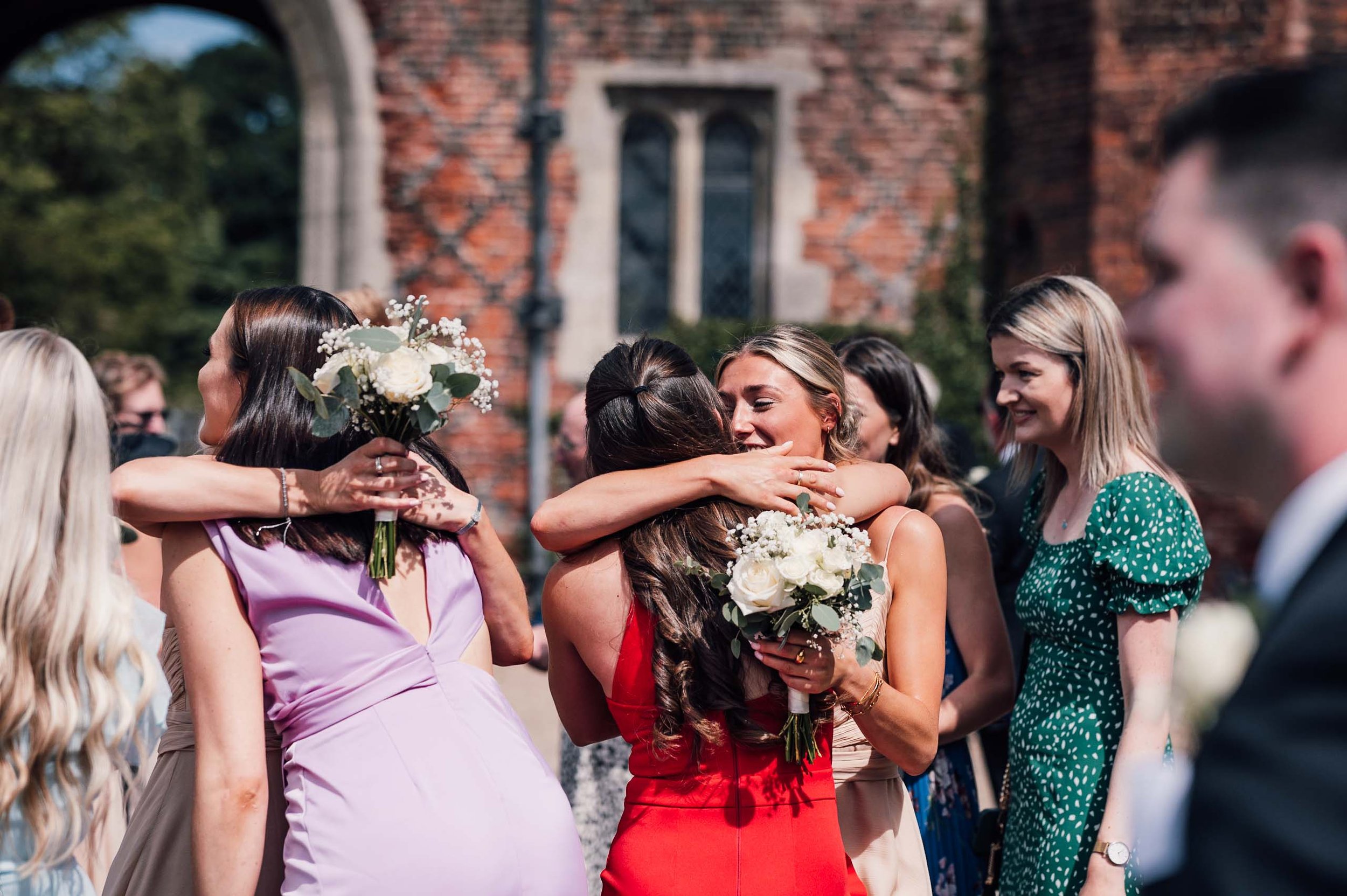 wedding guests hugging at Hodsock Priory