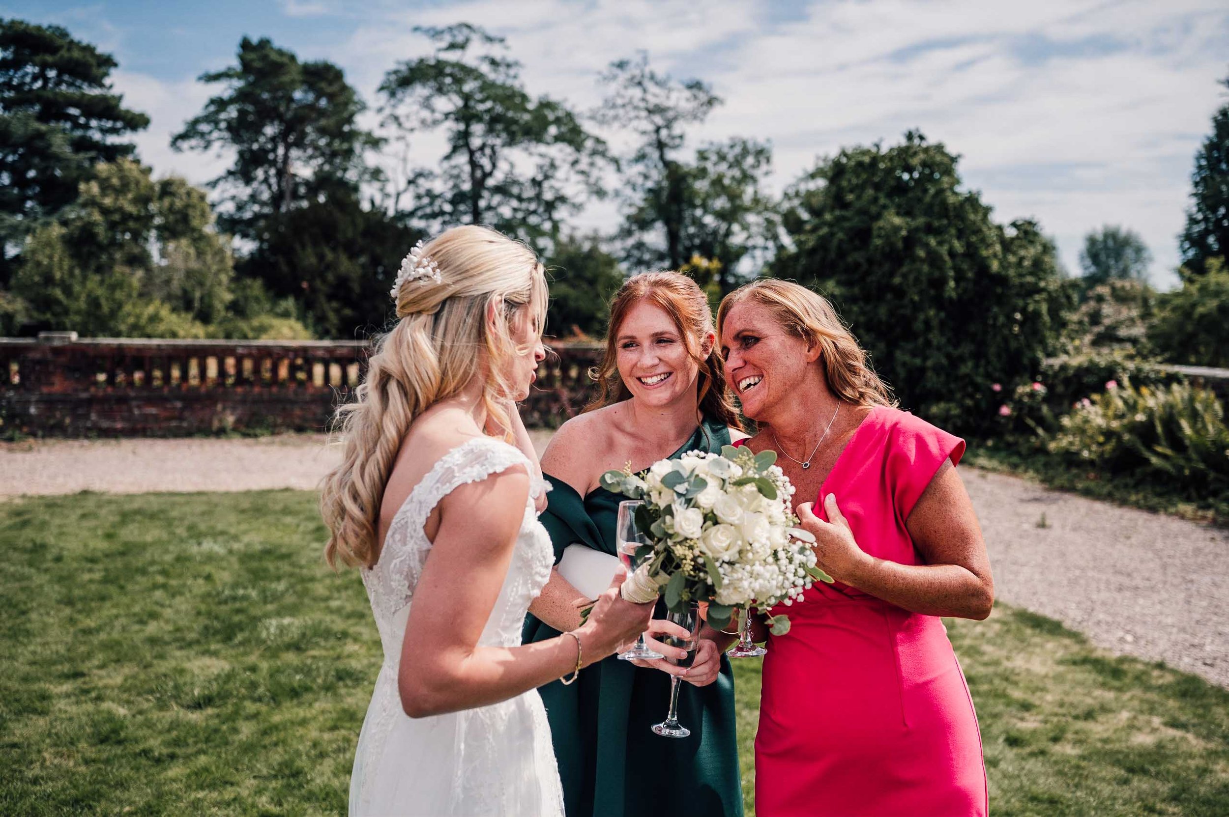 Bride having a laugh with her wedding guests at Hodsock Priory