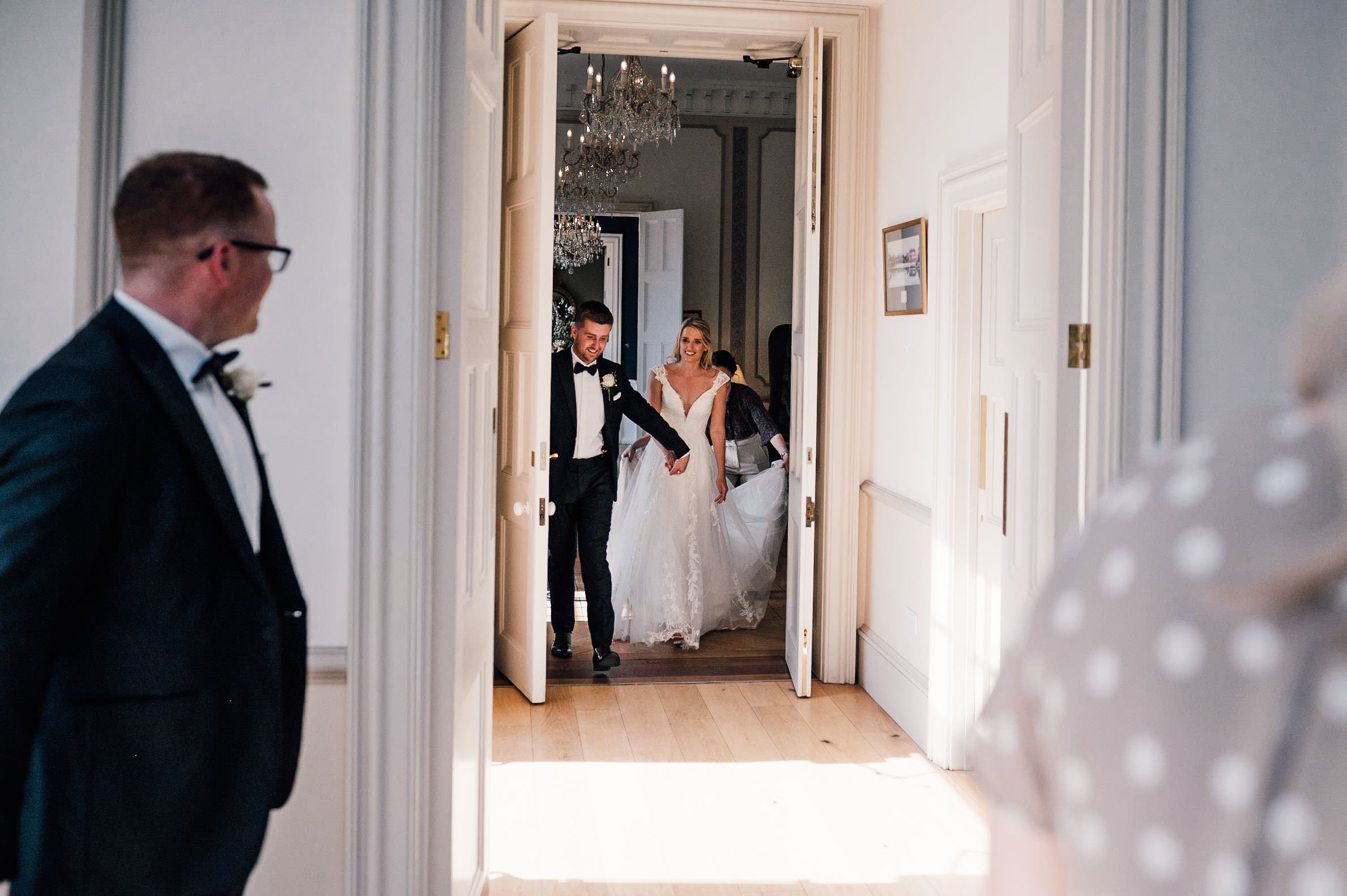 bride and groom entering the reception room at Hodsock Priory