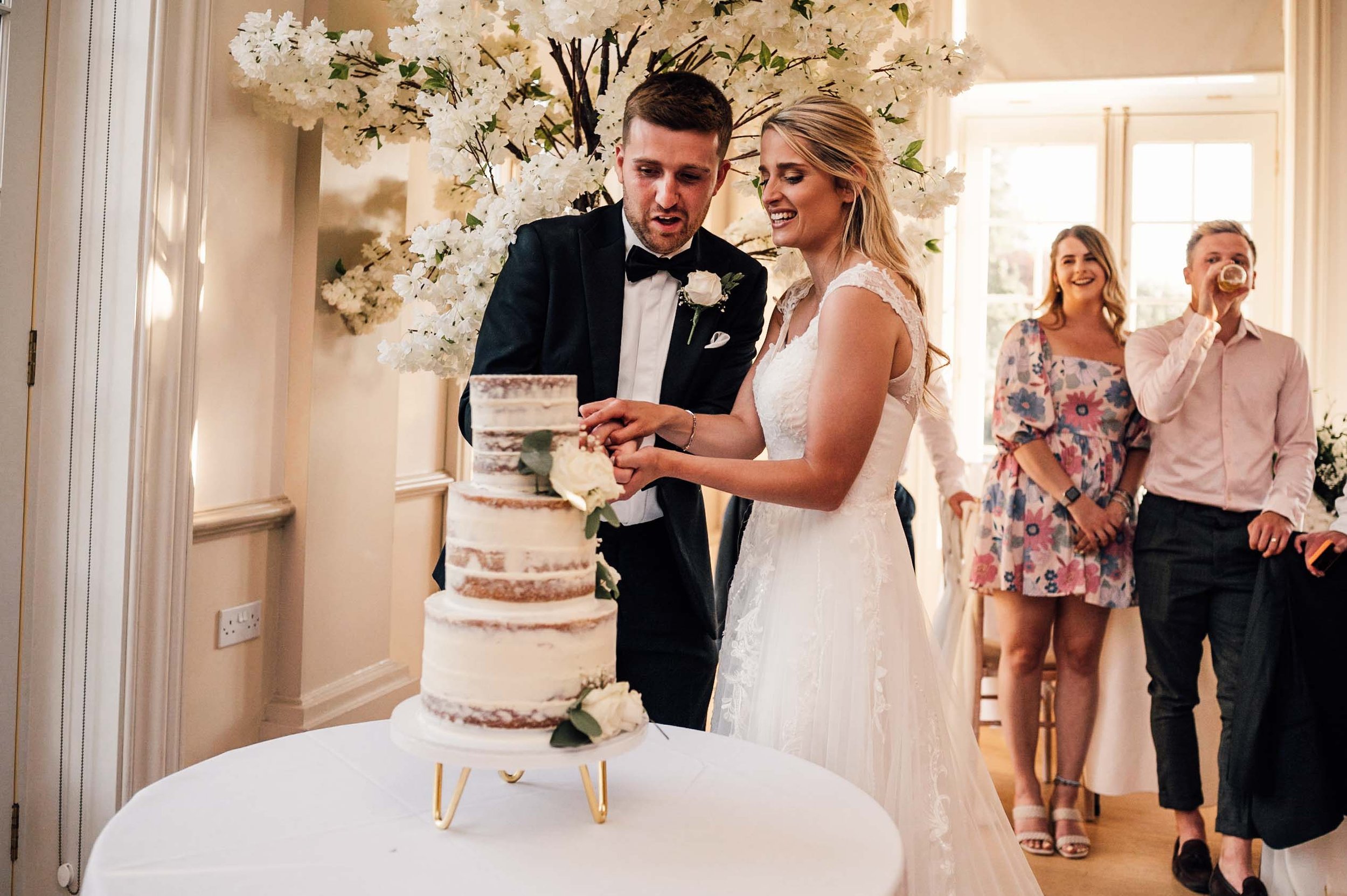 Bride and groom cutting the cake at Hodsock Priory