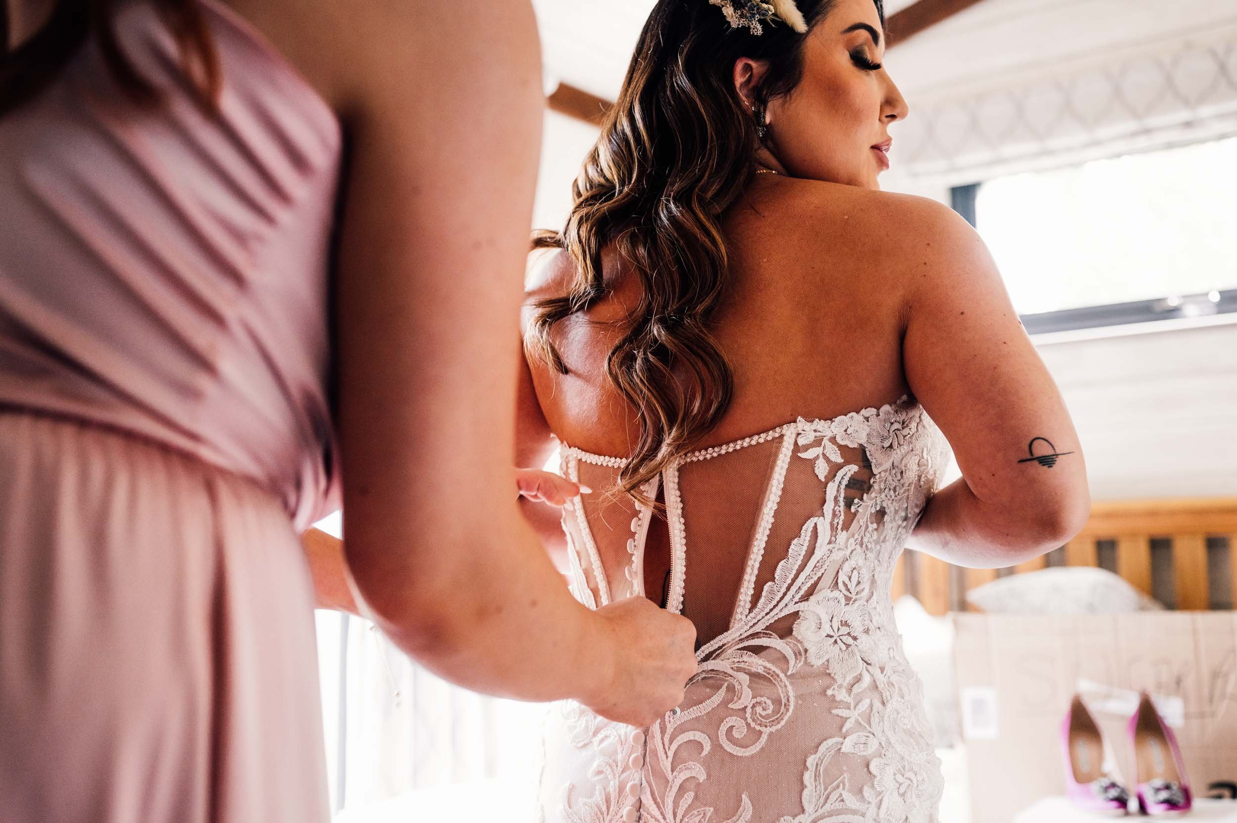 bride getting into her wedding dress