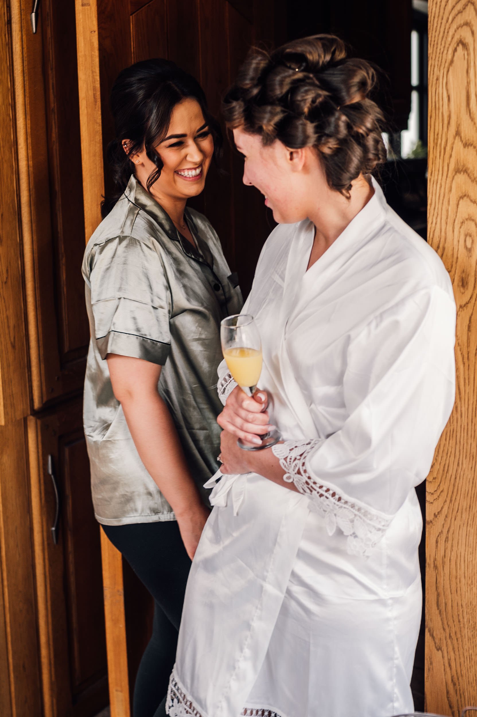 bride laughing with bridesmaid