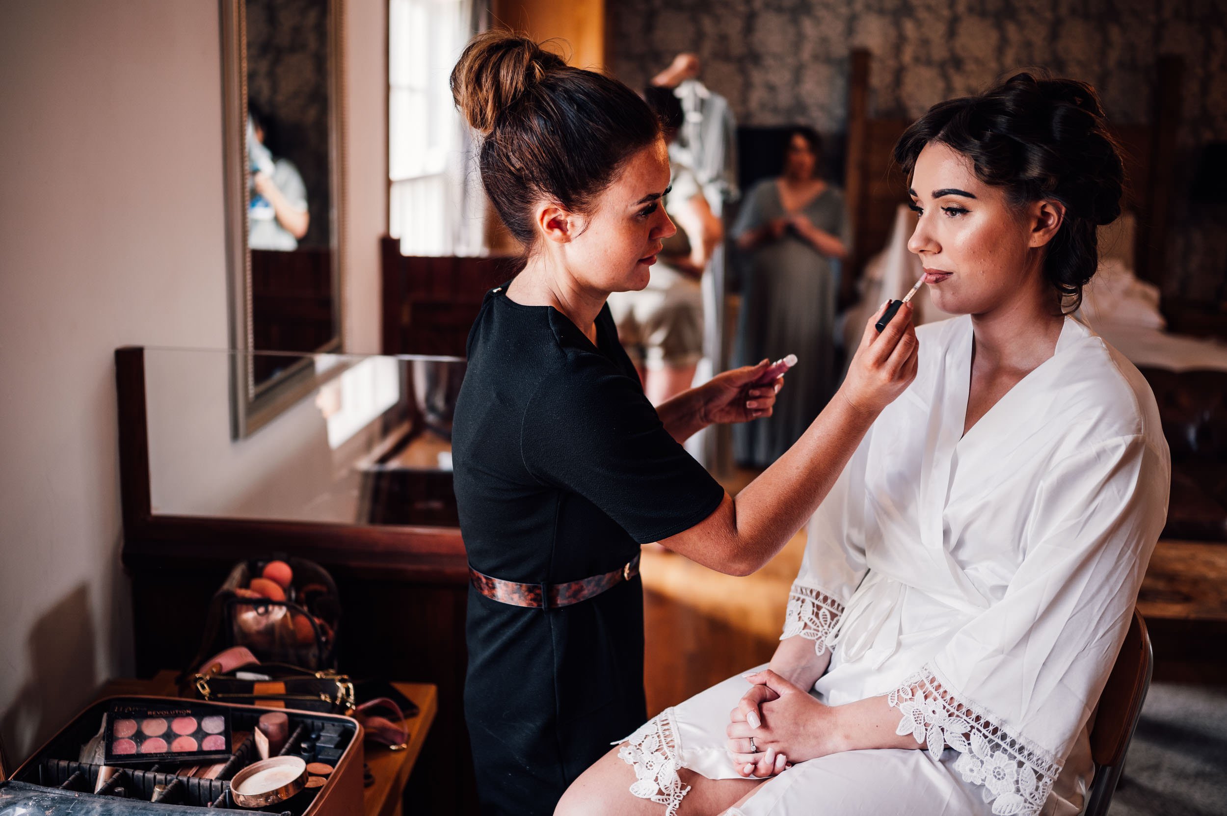 bride having her makeup applied at Swancar Farm