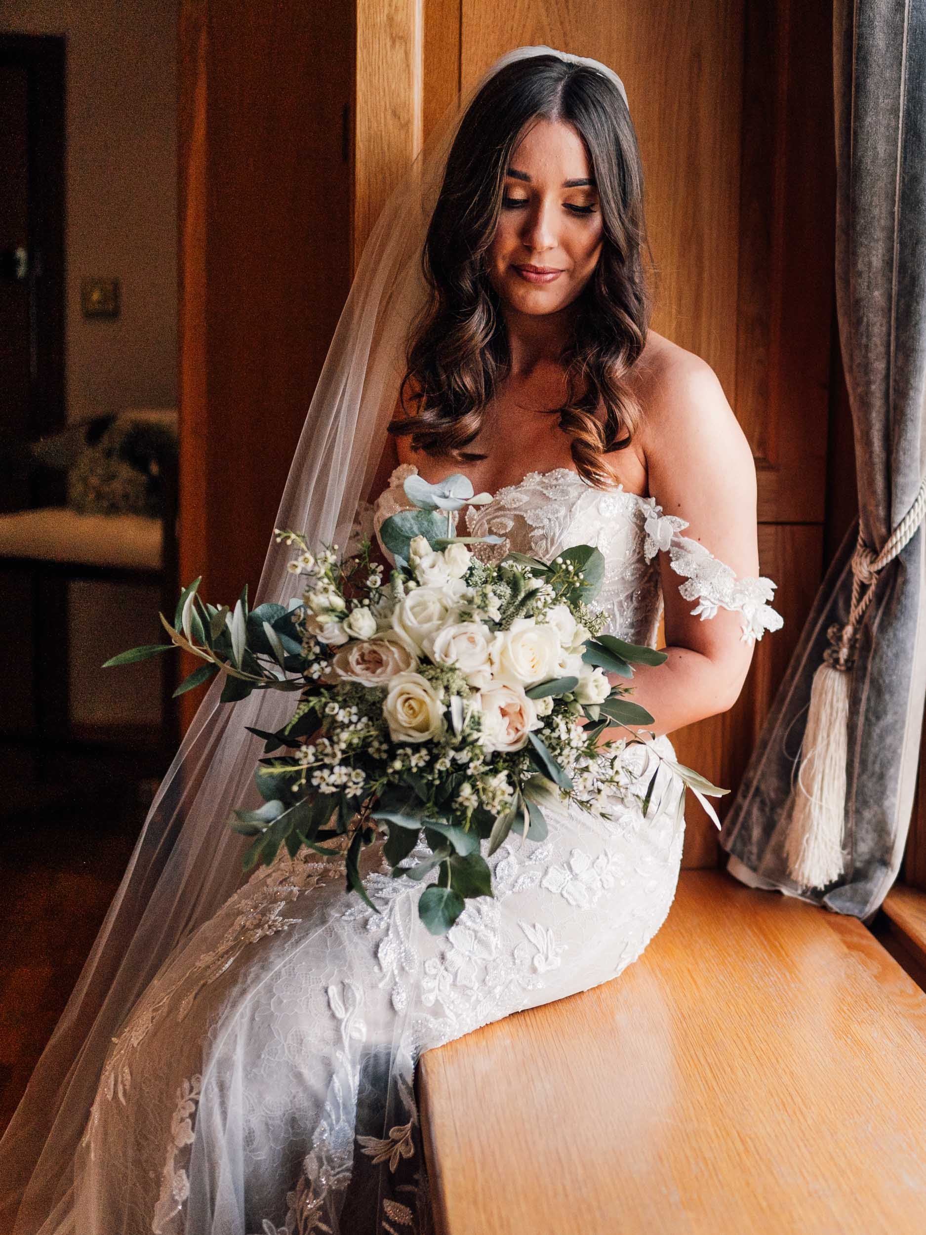 bride sitting inthe window light at Swancar Farm