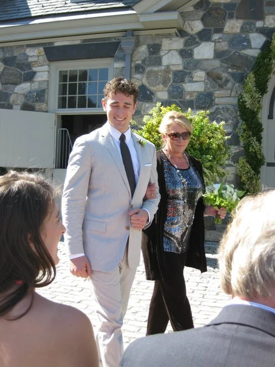 My mom walking with me at my wedding to Tim in 2010. My sister and dad are in the foreground.