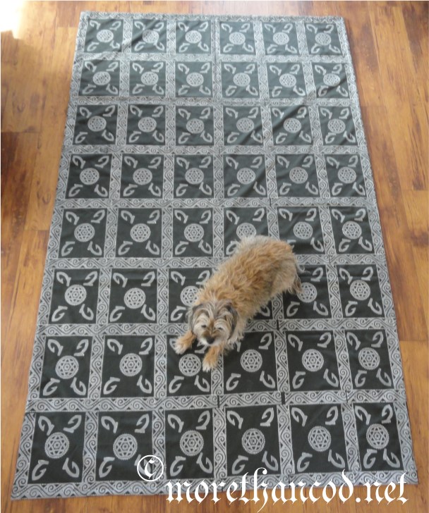 Full image of floor covering. FiberDog for scale.