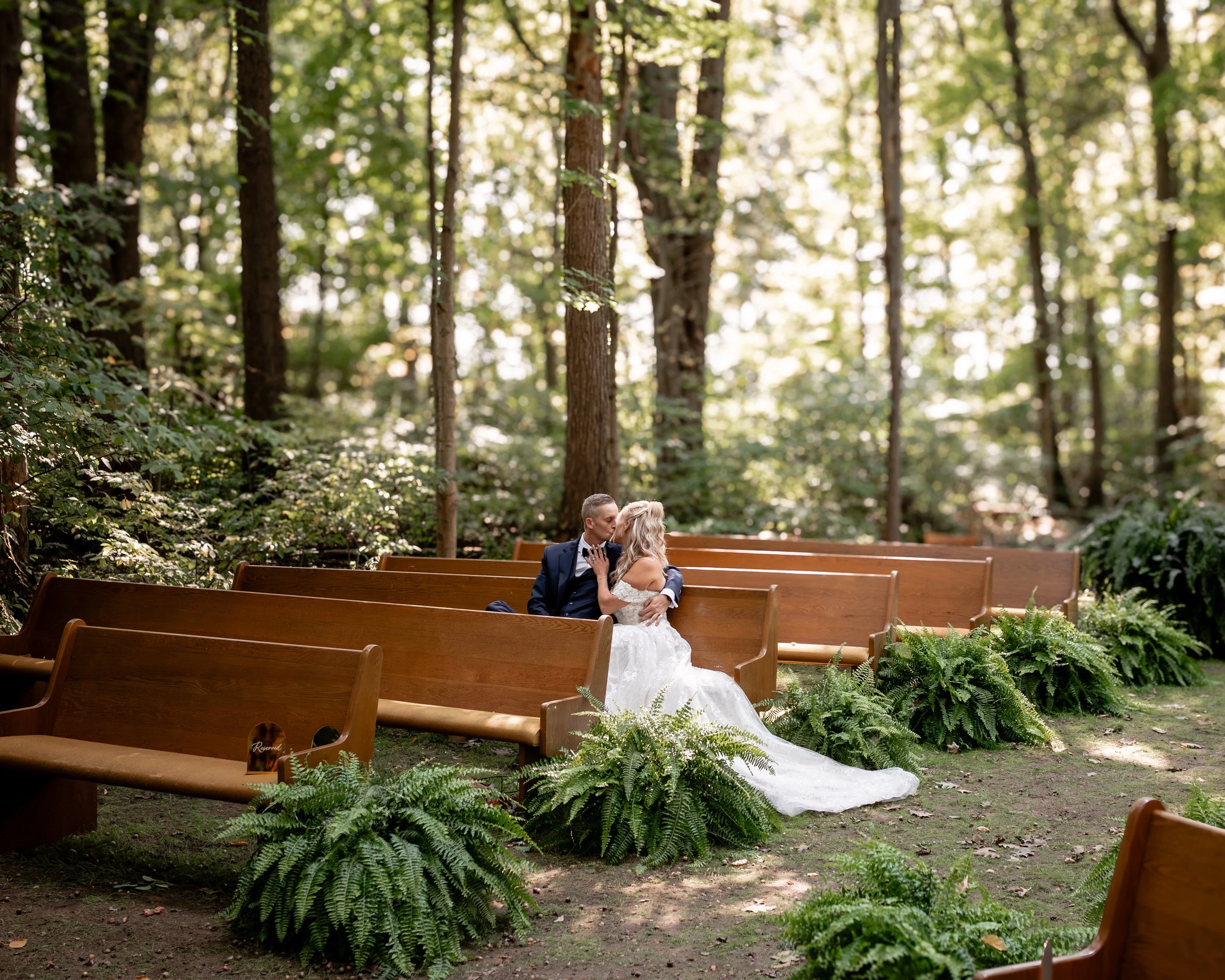 Luxury Niagara Wedding Photographer Captures a candid moment between bride and groom in gorgeous forrest setting.jpg