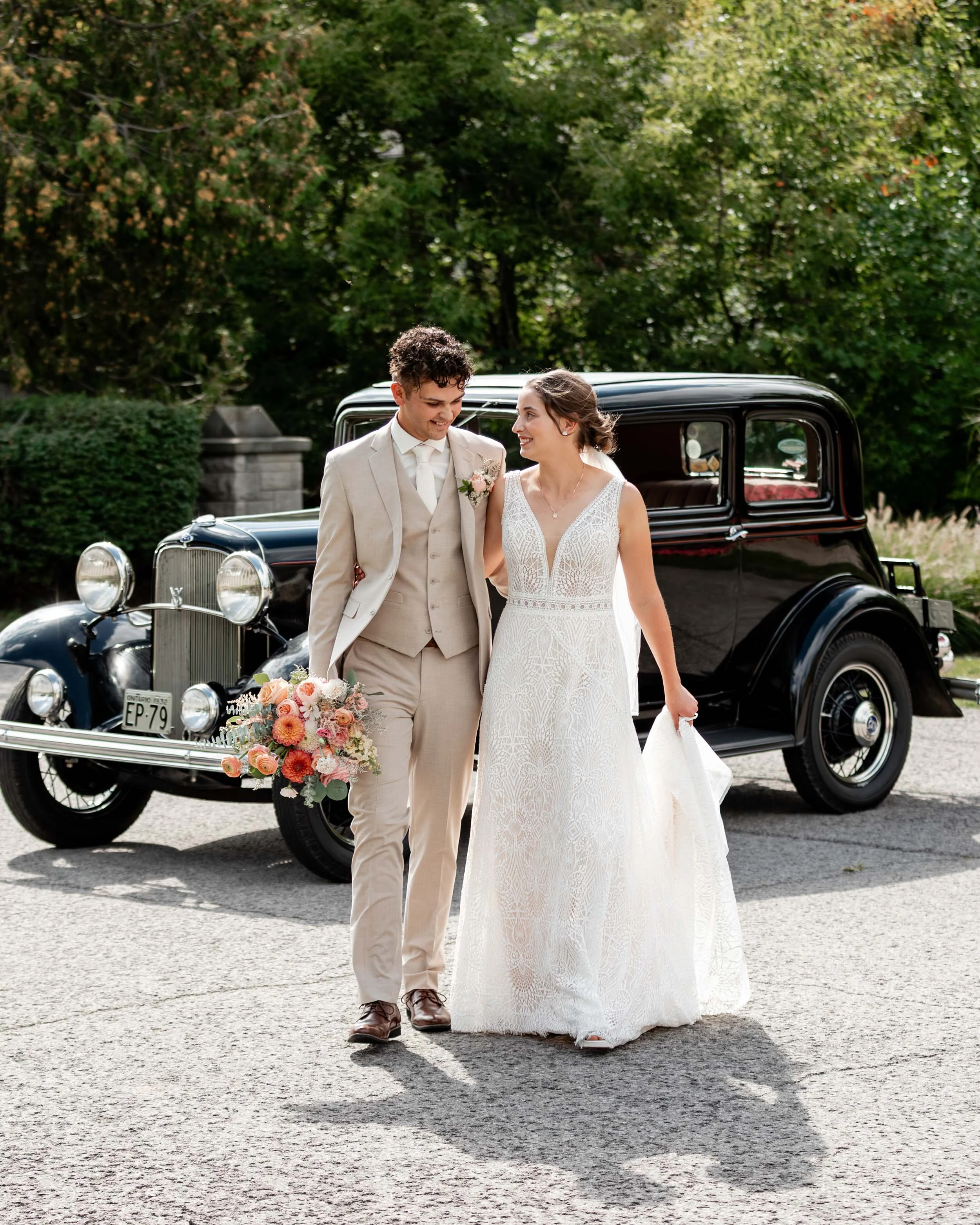 Timeless photos of wedding couple walking infront of calssic car in Niagara.jpg