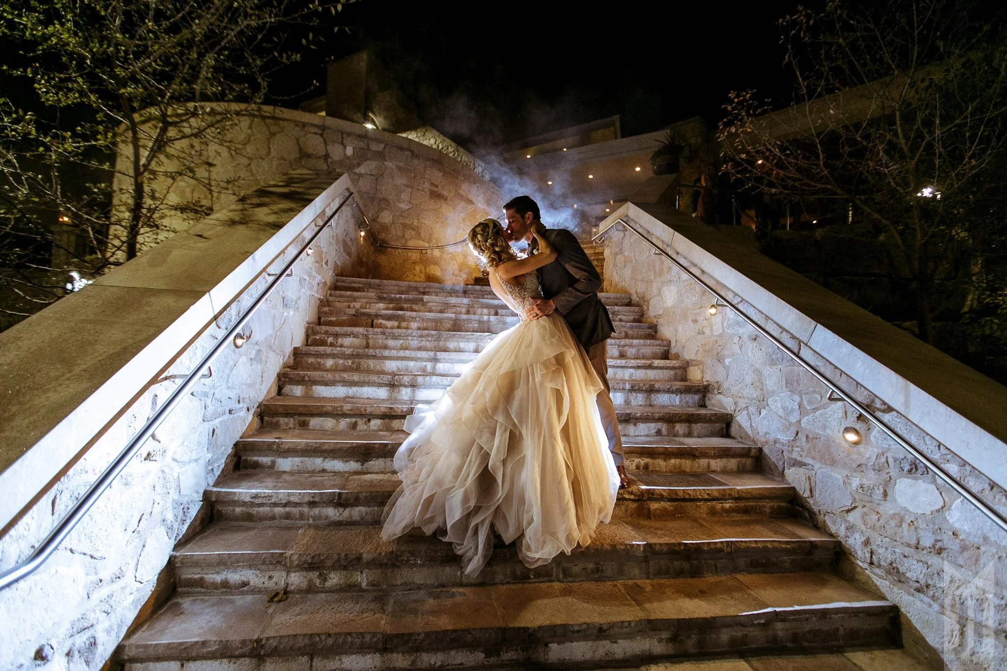Groom dips his bride on the steps of Cambridge Mill at a Luxury wedding captured by Jeremy James Photography.jpg