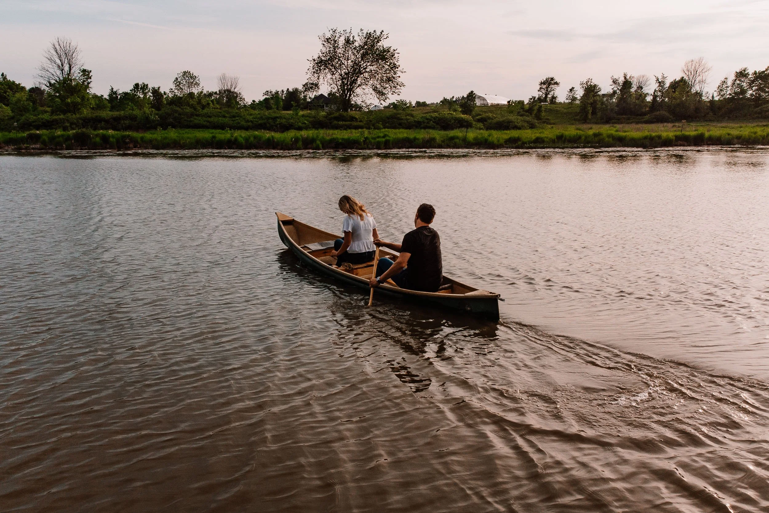 Cute engagement Photo of a couple in a canoe at sunset.jpg