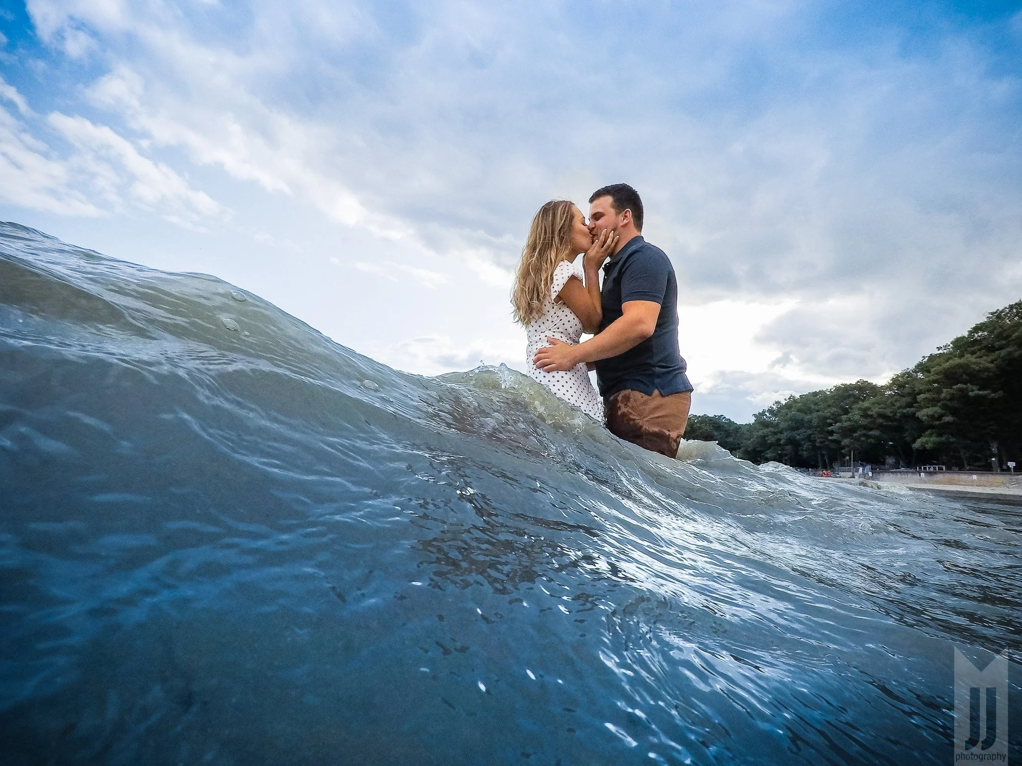 Couple Kisses in the water in a very creative engagement beach photo session in Niagara.jpg