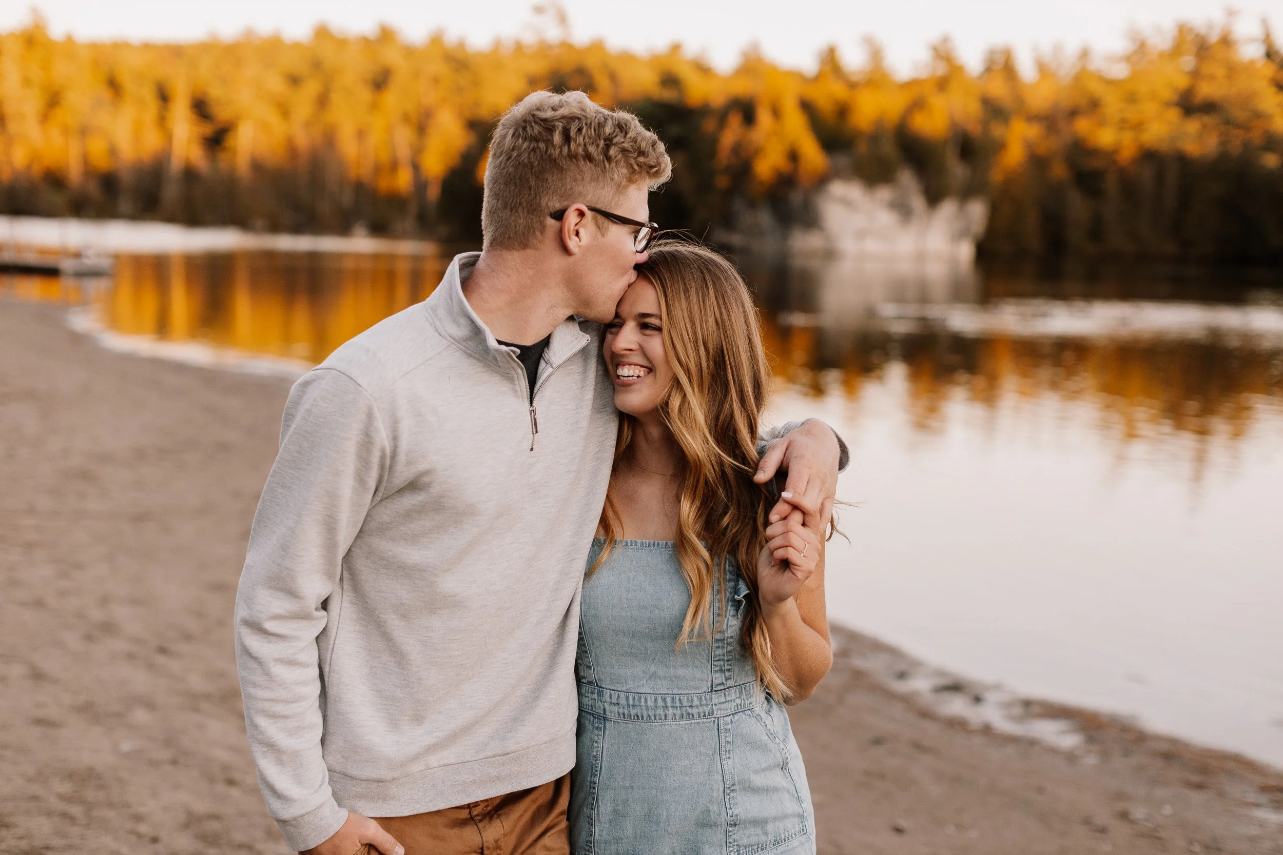 Cute Couple share a laugh while walking in the fall dor engagement photos.jpg