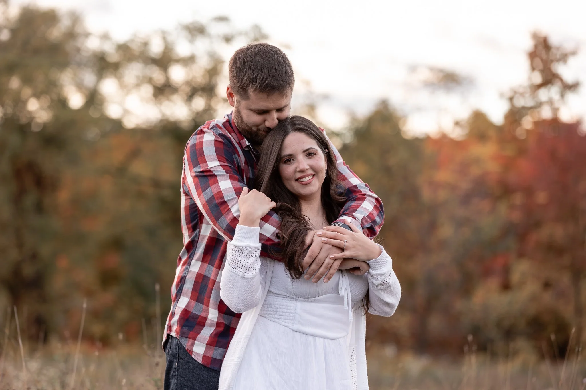 beautiful woman is held by her fiance in a fall engagement shoot in NIagara.jpg