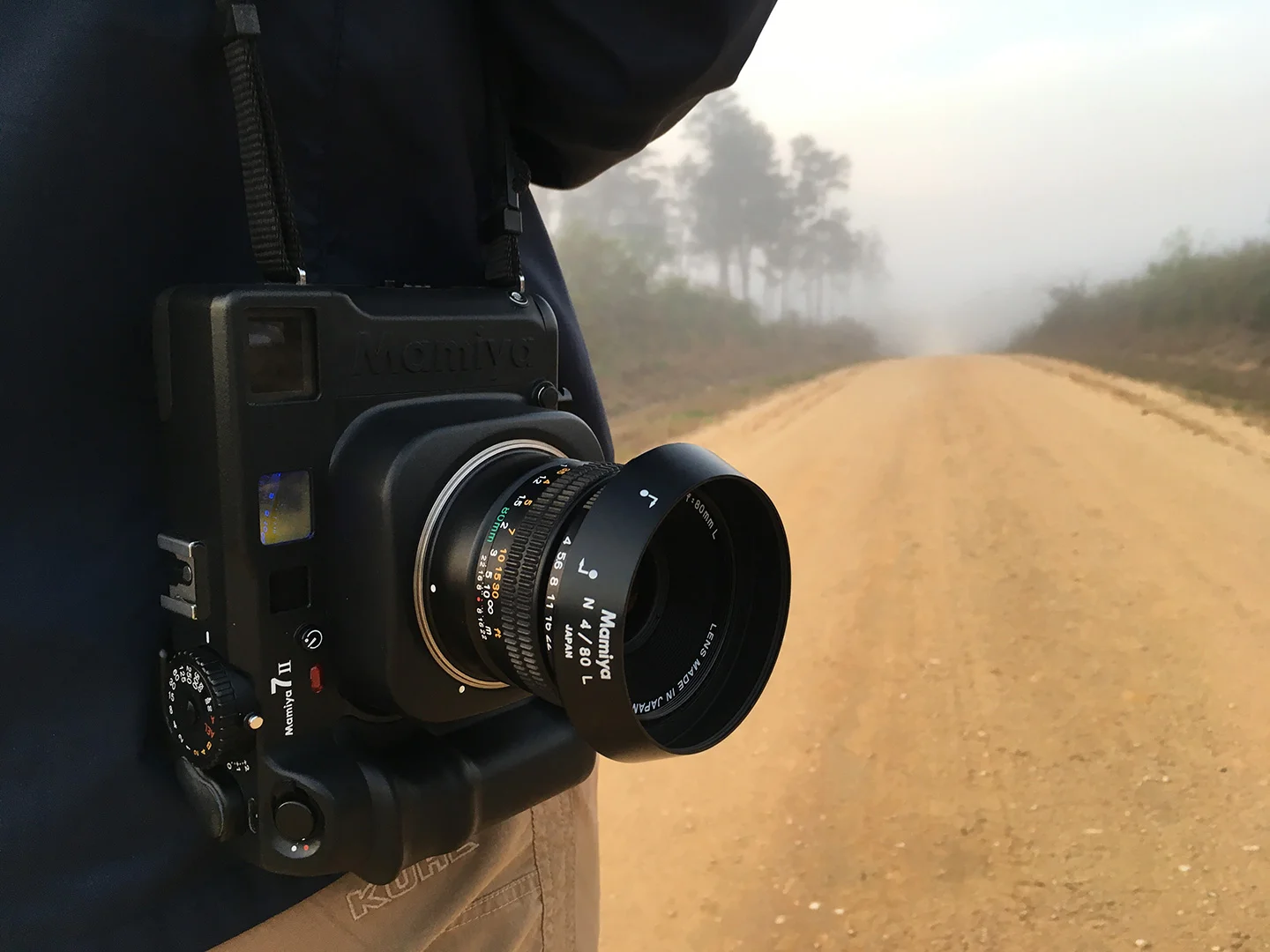 The Mamiya 7ii hangs from my shoulder as I meter the scene. Photo by Alex Catalano.