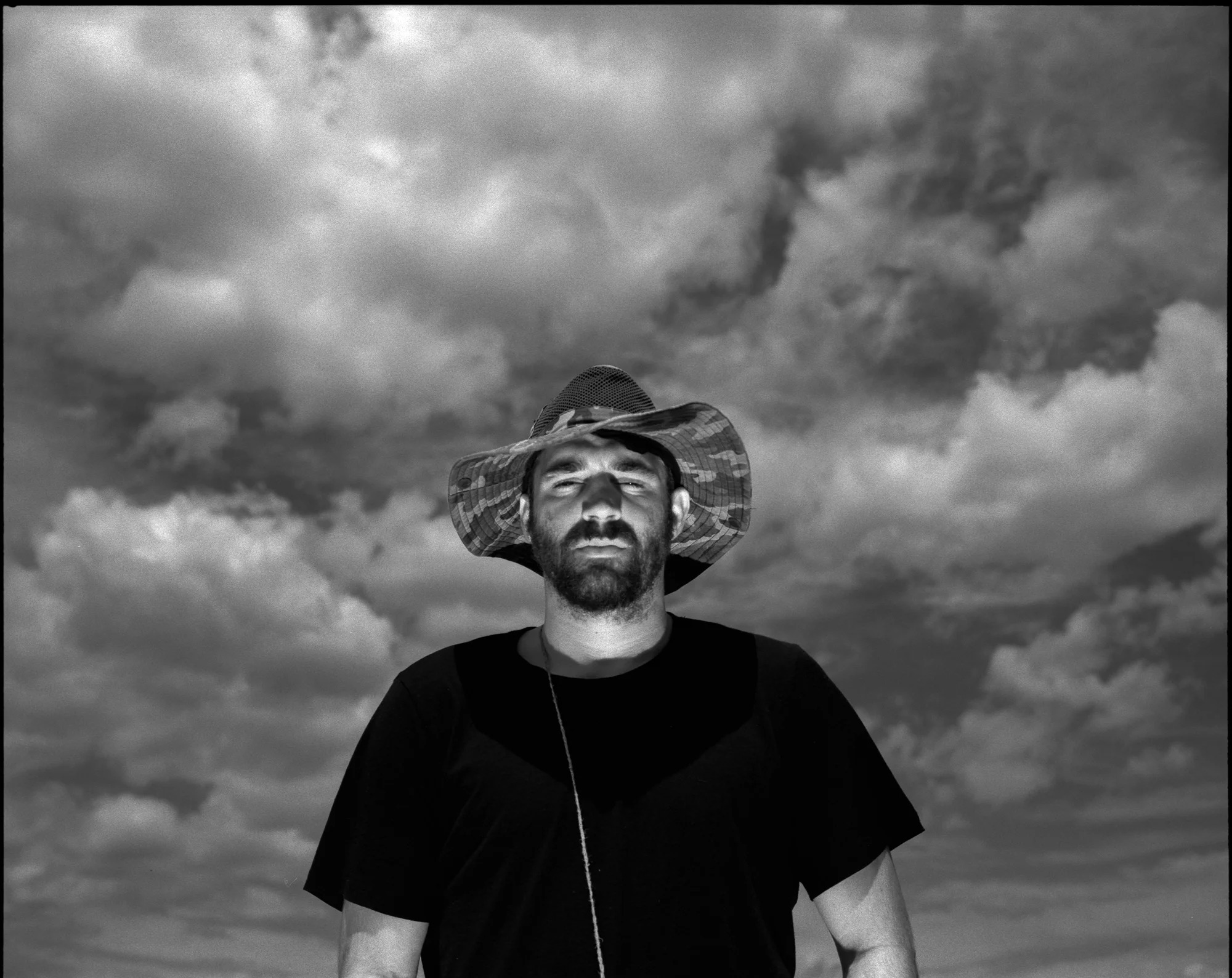 Alex stands for a portrait in front of the reflected mirror light in the Juniper Prairie Wilderness. Mamiya 7ii, 80mm, Kodak Tri-X 400 pushed to 1600.