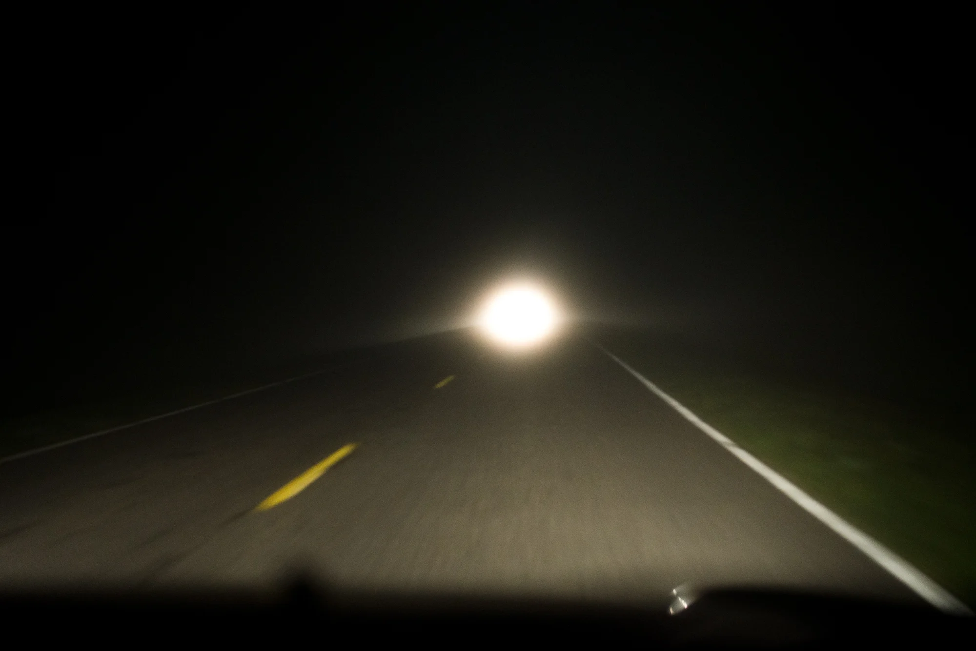 The headlights of a passing vehicle foreshadow the dawn of a new era in our Juniper Prairie Wilderness adventures.