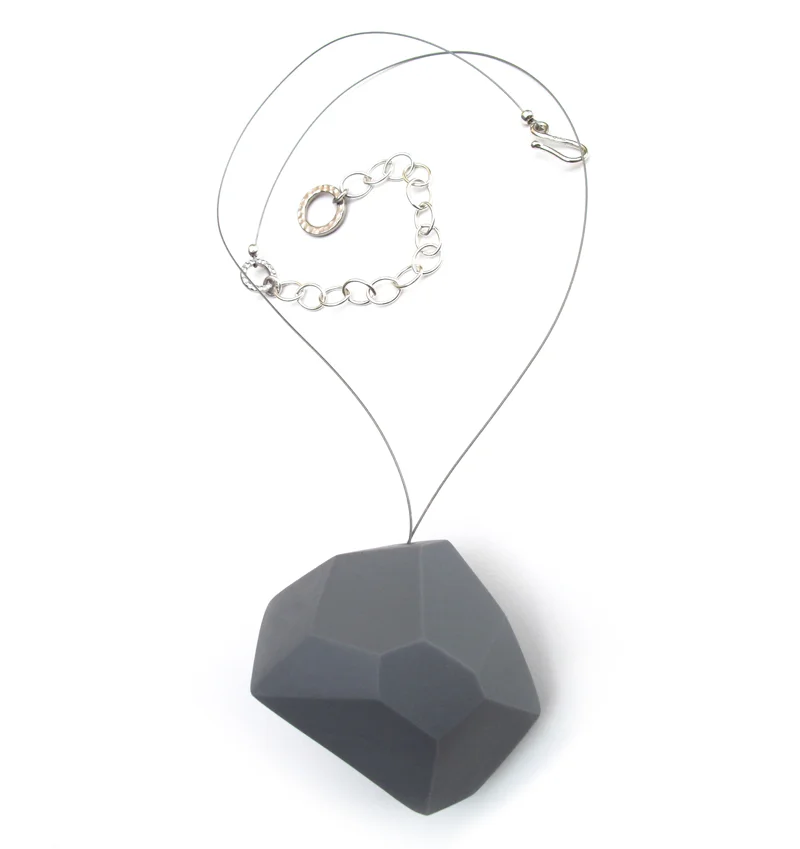   Aggregate/Wearable   Cast vitreous porcelain with silver findings. Largest Pin is 2"W × 1"H × 0.5"D Colors: white, black, pale gray, deep grey and blue.  A collection of bold yet lightweight pins and pendants.&nbsp; Pins are available in large, med