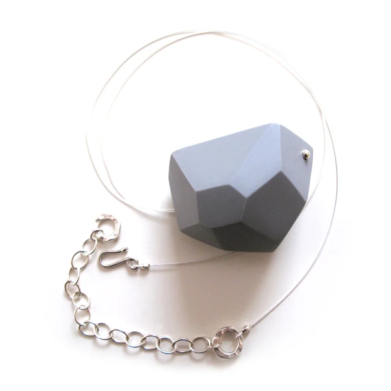   Aggregate/Wearable   Cast vitreous porcelain with silver findings. Largest Pin is 2"W × 1"H × 0.5"D Colors: white, black, pale gray, deep grey and blue.  A collection of bold yet lightweight pins and pendants.&nbsp; Pins are available in large, med