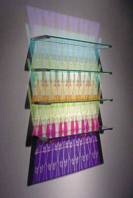   Aurora Shelving - Sullivan Pattern   Etched + Laminated Glass + Steel Wall Supports Various Dimensions  Glass shelving that   literally  paints  the wall with colored reflections when illuminated by a spotlight from above. There are no visible colo