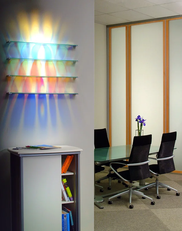   Aurora Shelving - Haworth Showroom, Michigan   Etched + Laminated Glass + Steel Wall Supports Various Dimensions  Glass shelving that   literally  paints  the wall with colored reflections when illuminated by a spotlight from above. There are no vi
