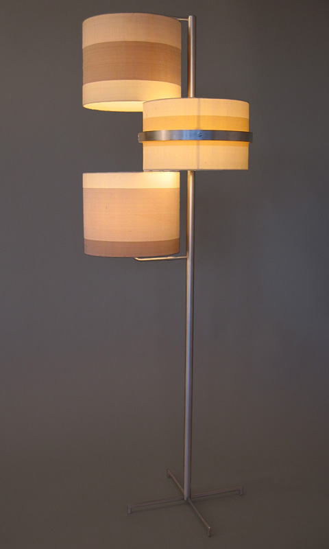   Swing Floor Lamp   Aluminum Frame + 3-Part Silk Shade 60”H X 14”DIAMETER  The  Swing Floor Lamp  is a multi-tasker in disguise. It gives off a warm, ambient illumination while also providing task lighting when needed. The middle section of the thre