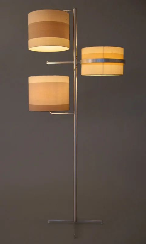   Swing Floor Lamp   Aluminum Frame + 3-Part Silk Shade 60”H X 14”DIAMETER  The  Swing Floor Lamp  is a multi-tasker in disguise. It gives off a warm, ambient illumination while also providing task lighting when needed. The middle section of the thre