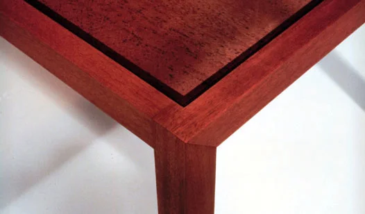   Utsurio Dining Table   Mahogany + Glass + Photographic Film 30”H X 40”W X 60”L  The glass top has an enlarged image of mahogany wood grain printed on graphic film that is permanently adhered to its underside. 