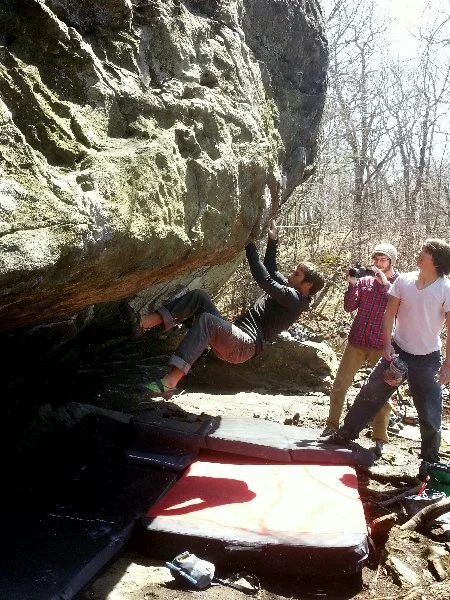 Kevin Joregeson nearly sending Hueco Nightmares, V11, in the Pond Cave at Lincoln Woods, RI. Photograph by Joe McLoughlin