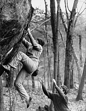 Janet Bergman climbing at Lincoln Woods, Rhode Island, while Rio Rose provides the supportive spot.